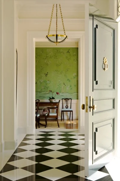 This design by Elizabeth Dinkel elicits the beauty that comes from stately checkered flooring. The intricate wallpaper and brushed gold accents work to add a sense of delicacy. | Photography by Karyn Millet