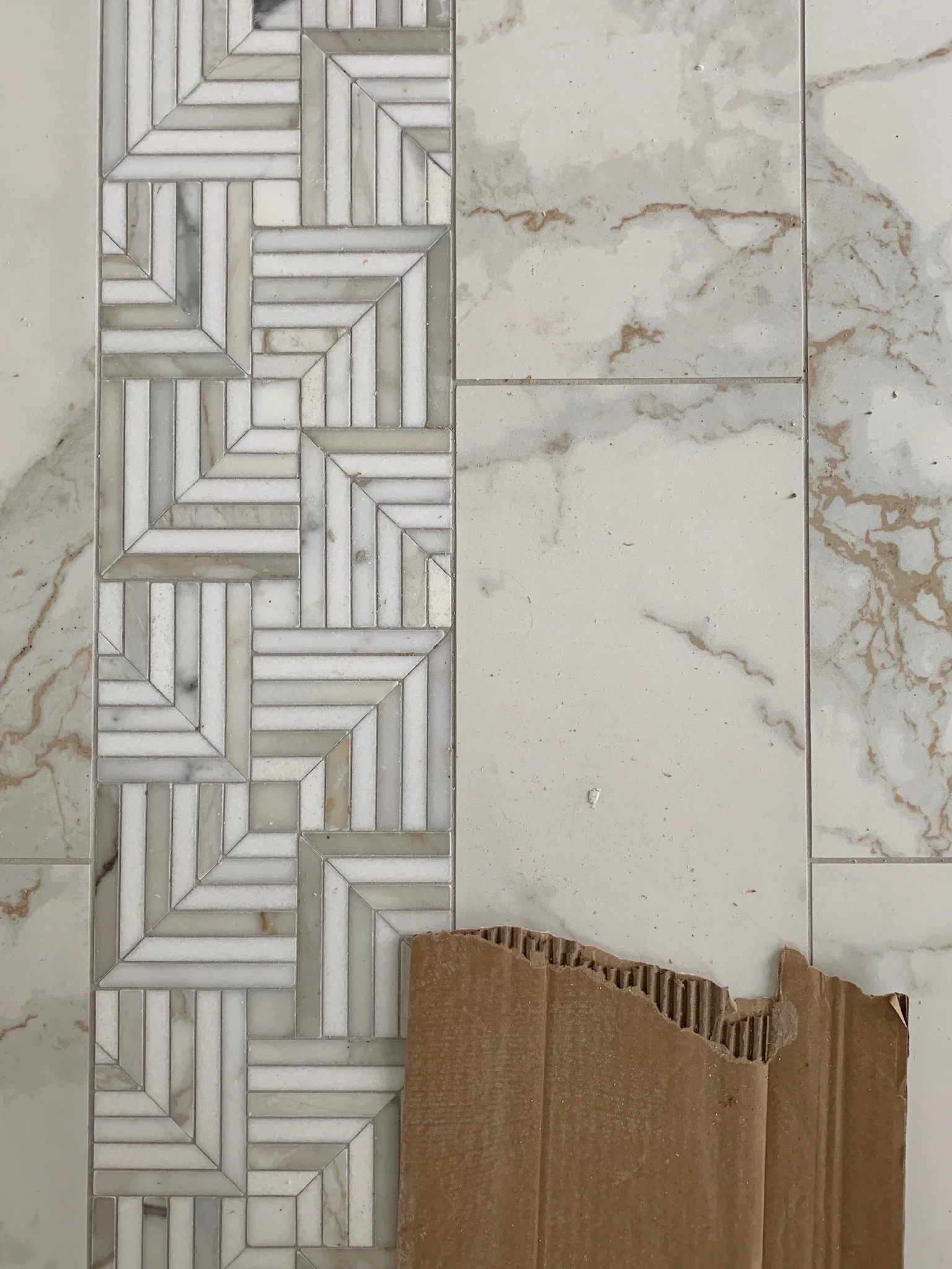 This warm-toned mosaic is marble! Such a sophisticated look for this space.