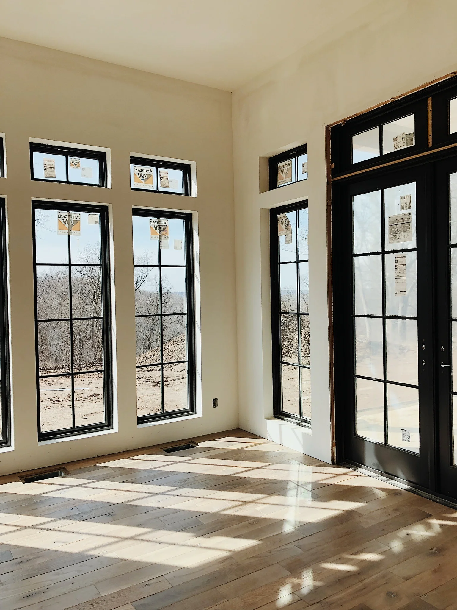 This amazing dining room features three full walls of windows. We skipped the trim around the windows for a clean, more minimalist look.