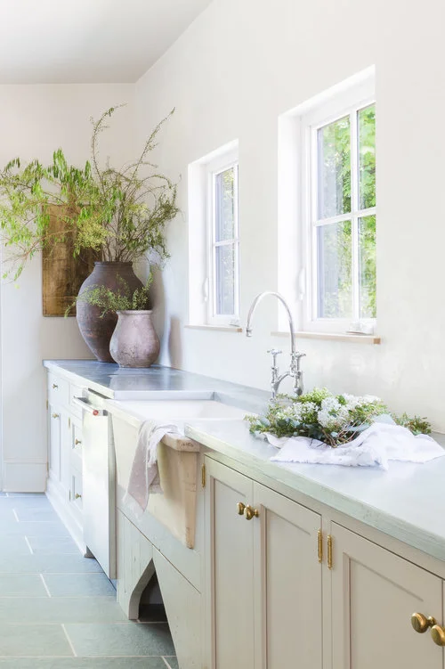 Natural light floods the space from square windows above the farmhouse sink. (Photography by Alyssa Rosenheck )