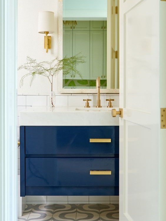 Deep blue is tied into the bathroom in this double drawer sink vanity.