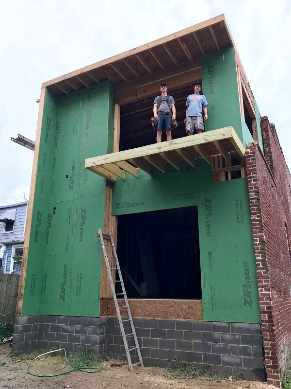 Pat (left) and Hunter showing off the balcony on our newly framed Church Hill addition.