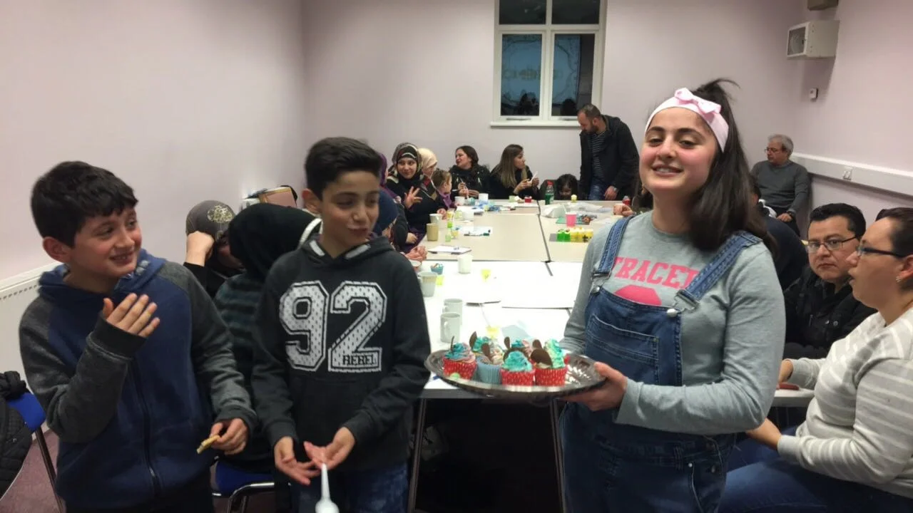 Children with cakes donated from Bake for Syria during adults’ English conversation classes