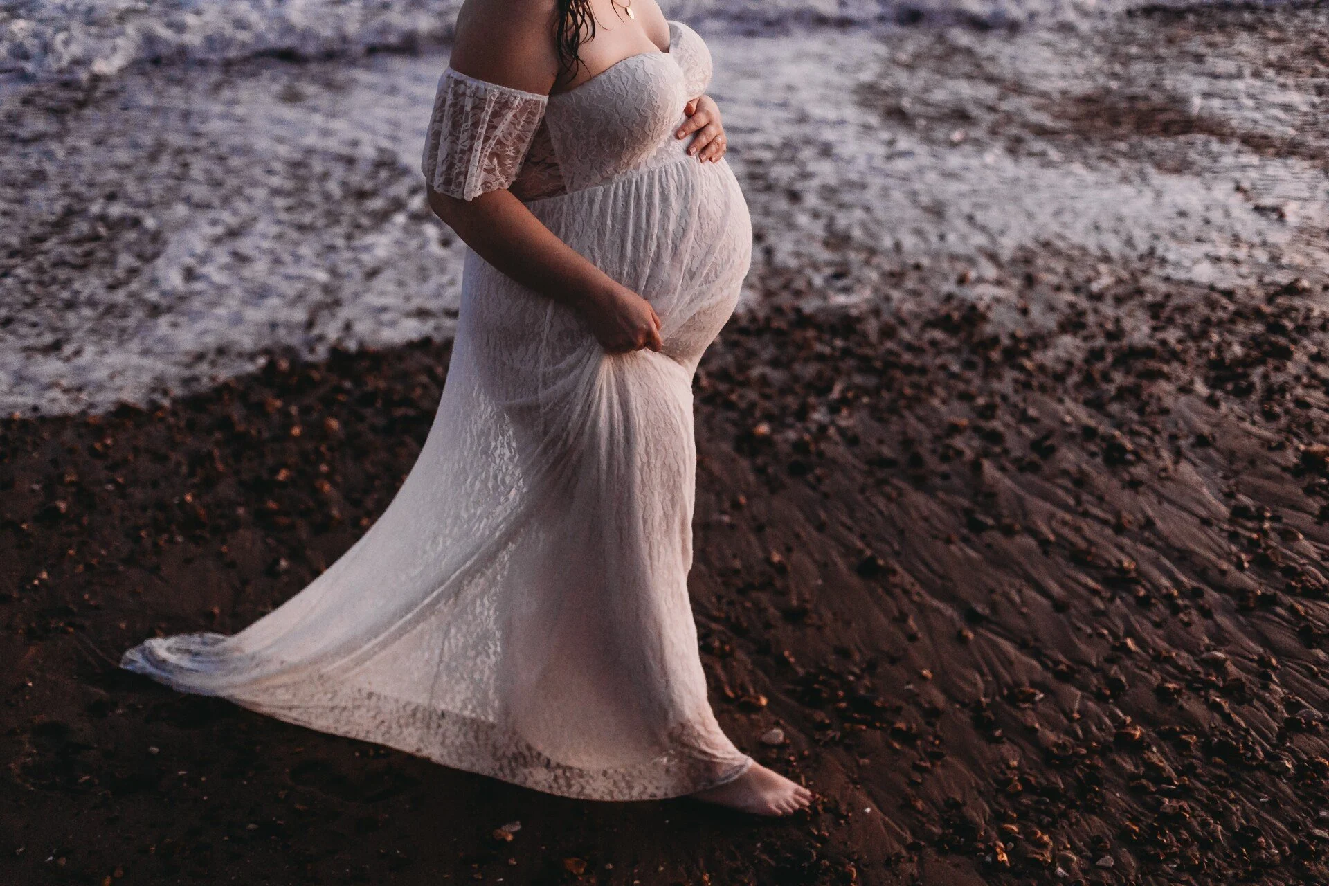 Maternity beach photo in lacey dress
