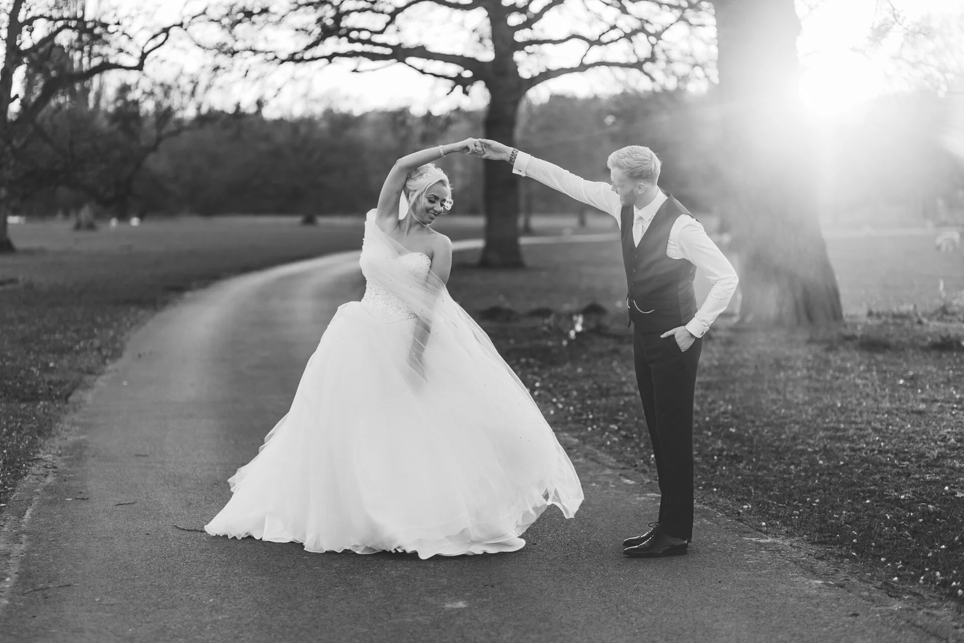Bride and groom dancing at sunset