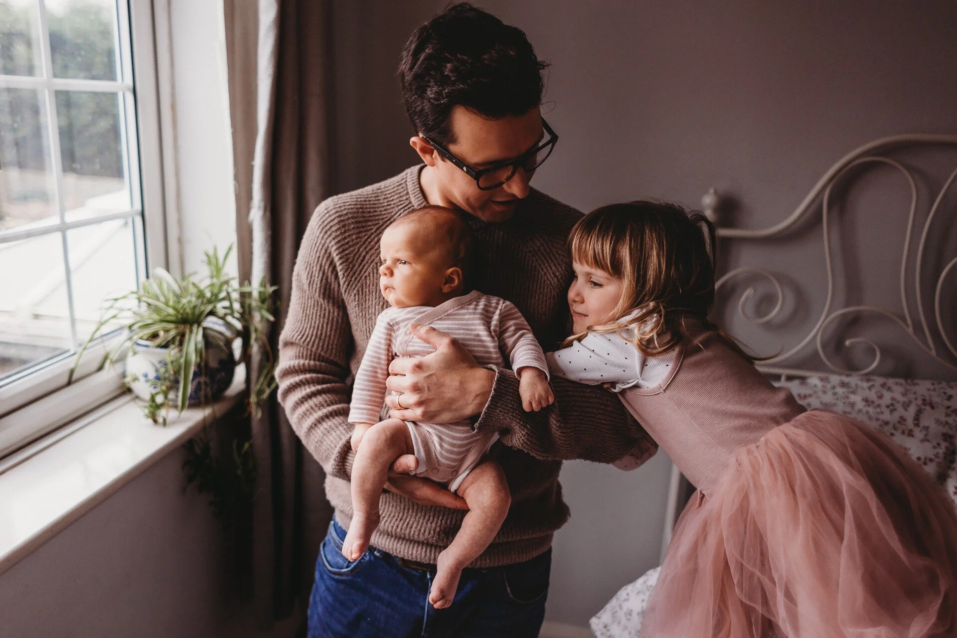 Dad, daughter and baby in home photo