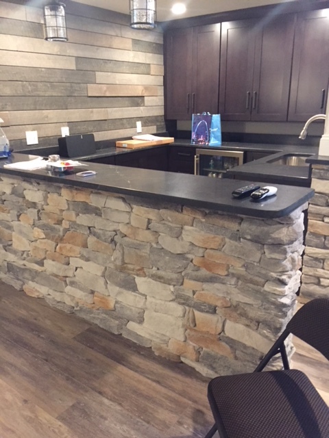 Stacked stone bar with mocca finish cabinets
