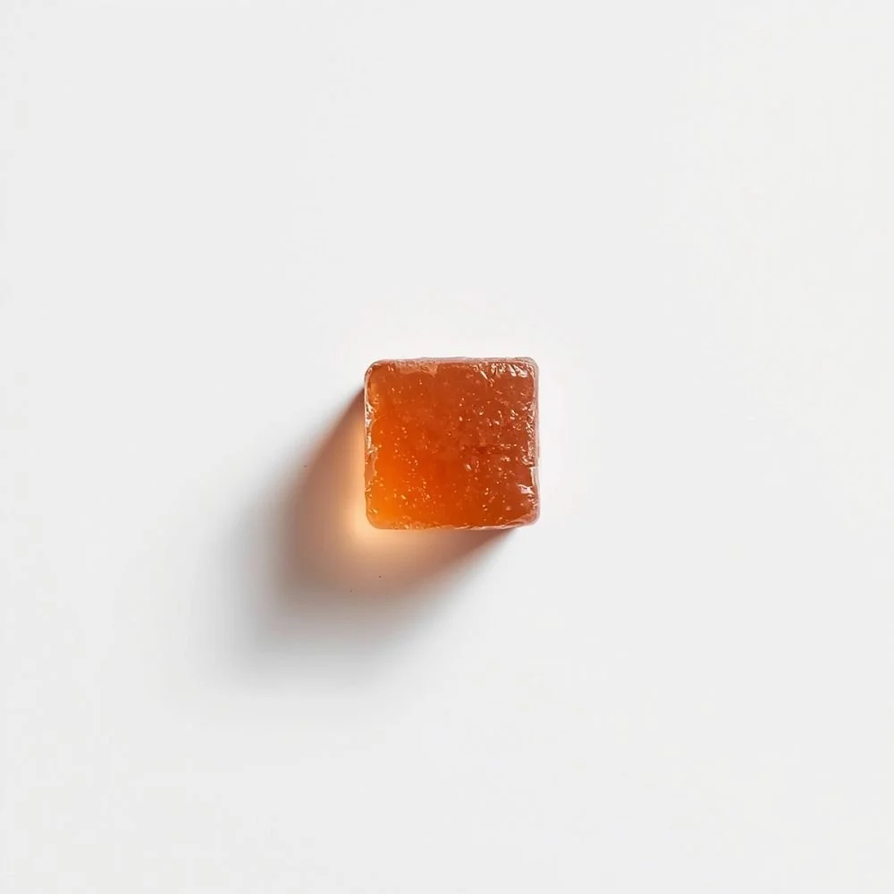  A single beef bouillon cube on a white surface, shot from above 