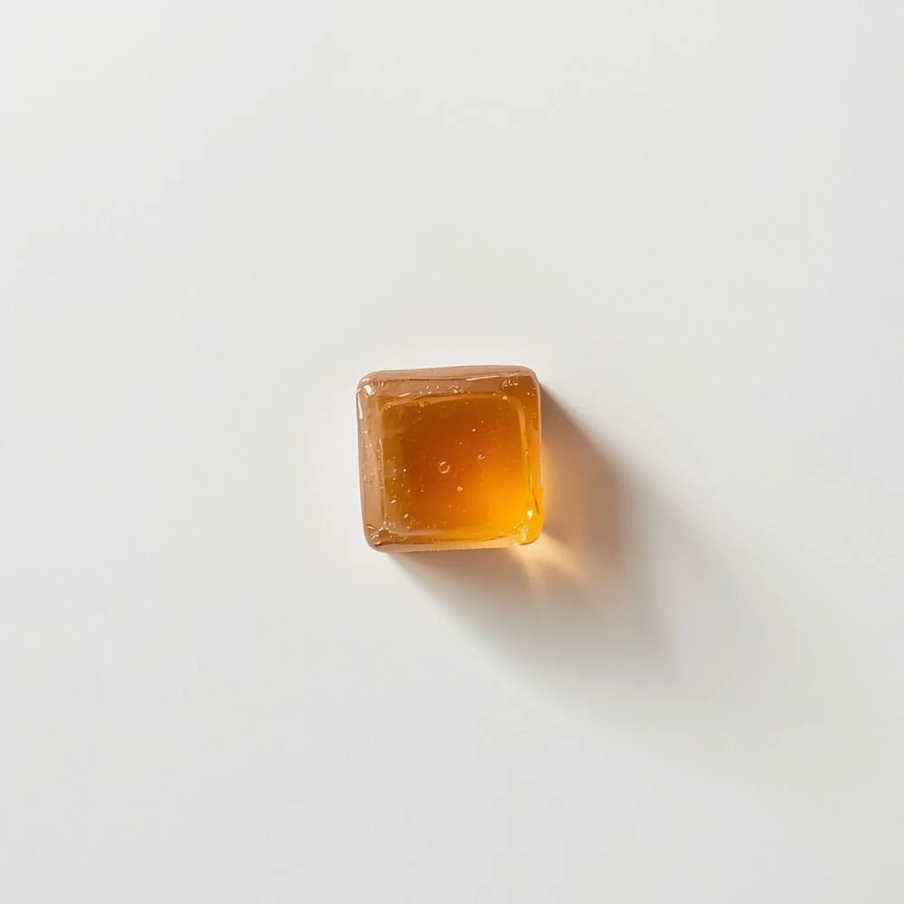  A single beef bouillon cube on a white surface, shot from above 