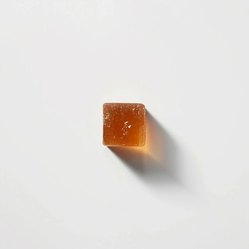  A single beef bouillon cube on a white surface, shot from above 