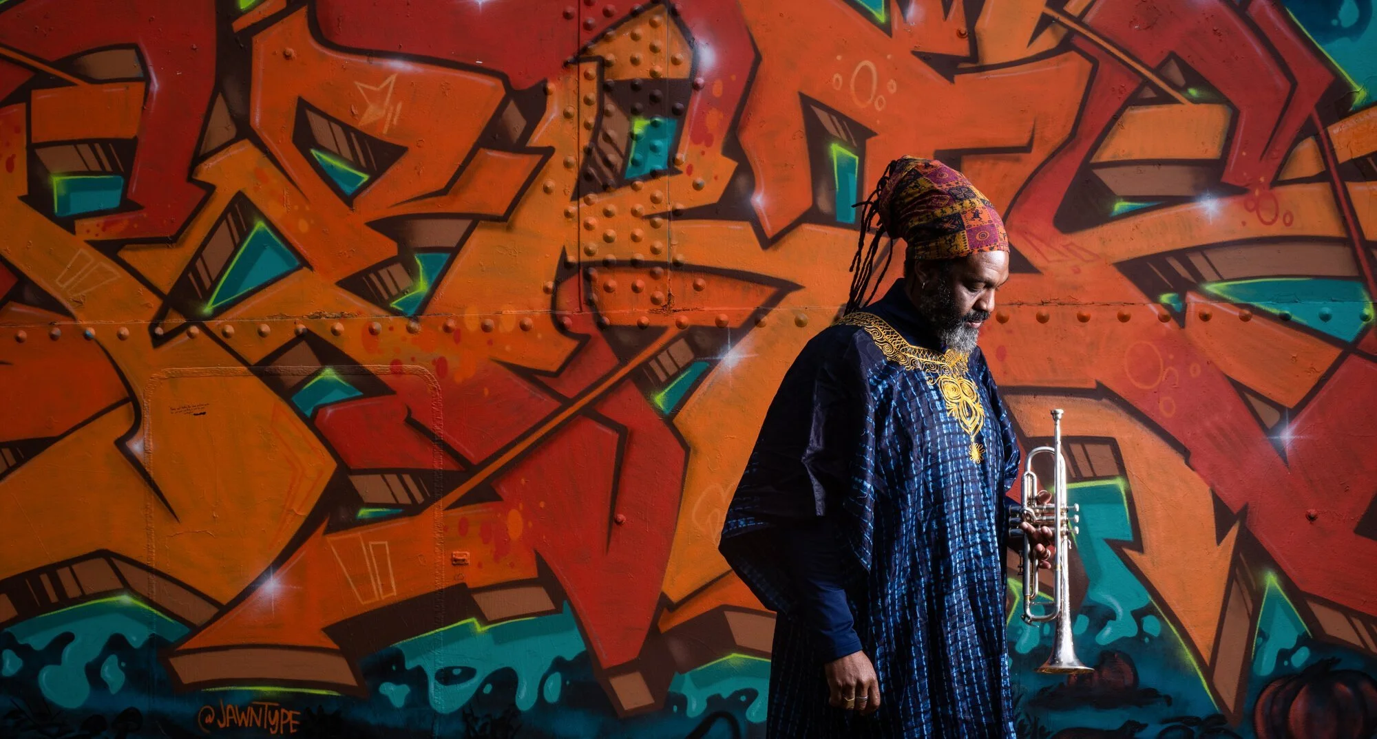  Herb Smith, a music educator at Rochester Institute of Technology (RIT) holds his trumpet in front of a mural at Cobbs Hill Park, in Rochester, N.Y., on October 25, 2020. Smith instructs multiple jazz ensembles, is a professional jazz and classical 