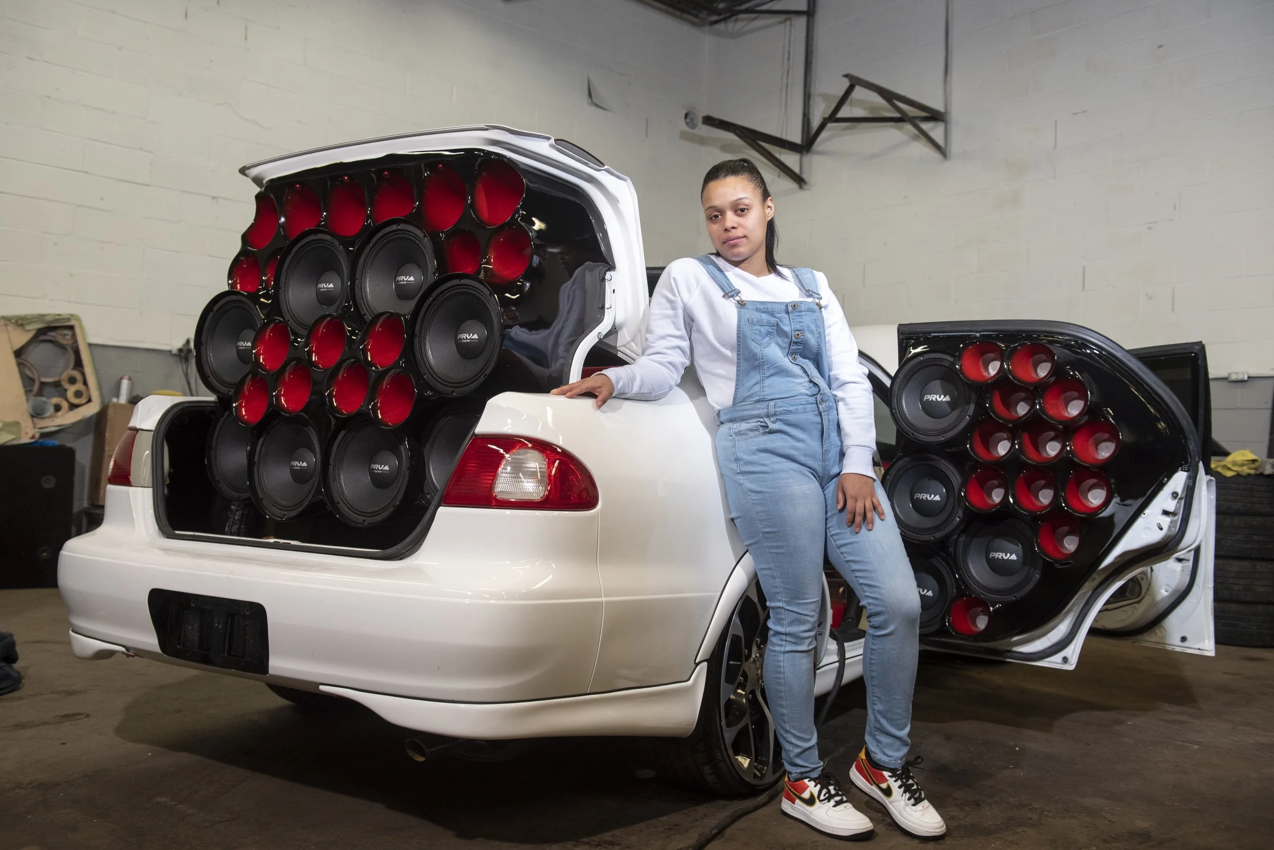  Mileika Dávila, a manager of Los Maniaticos, a 35 person Puerto Rican car group, poses for a portrait on Jan. 23, 2022. Cars are fitted with customized speaker systems that play Reggaeton music for events and competitions. This cultural practice com