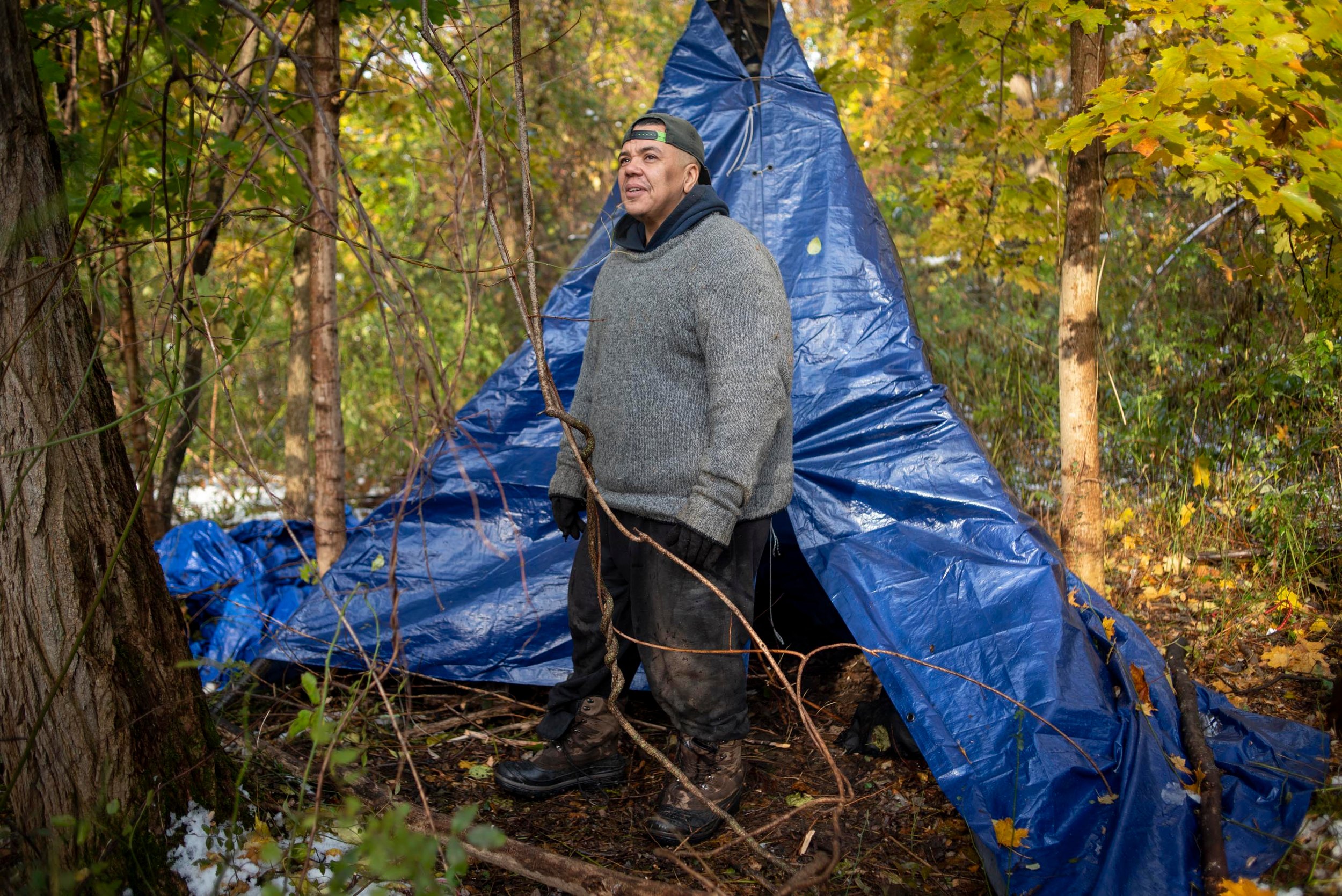  Kenzo Morris looks in awe at the sun shining through the woods while he sleeps outside in the cold for three full days in Laconia, N.H., on Nov. 10, 2023. Morris is raising awareness of homelessness in Laconia, and raising money for a mobile outreac