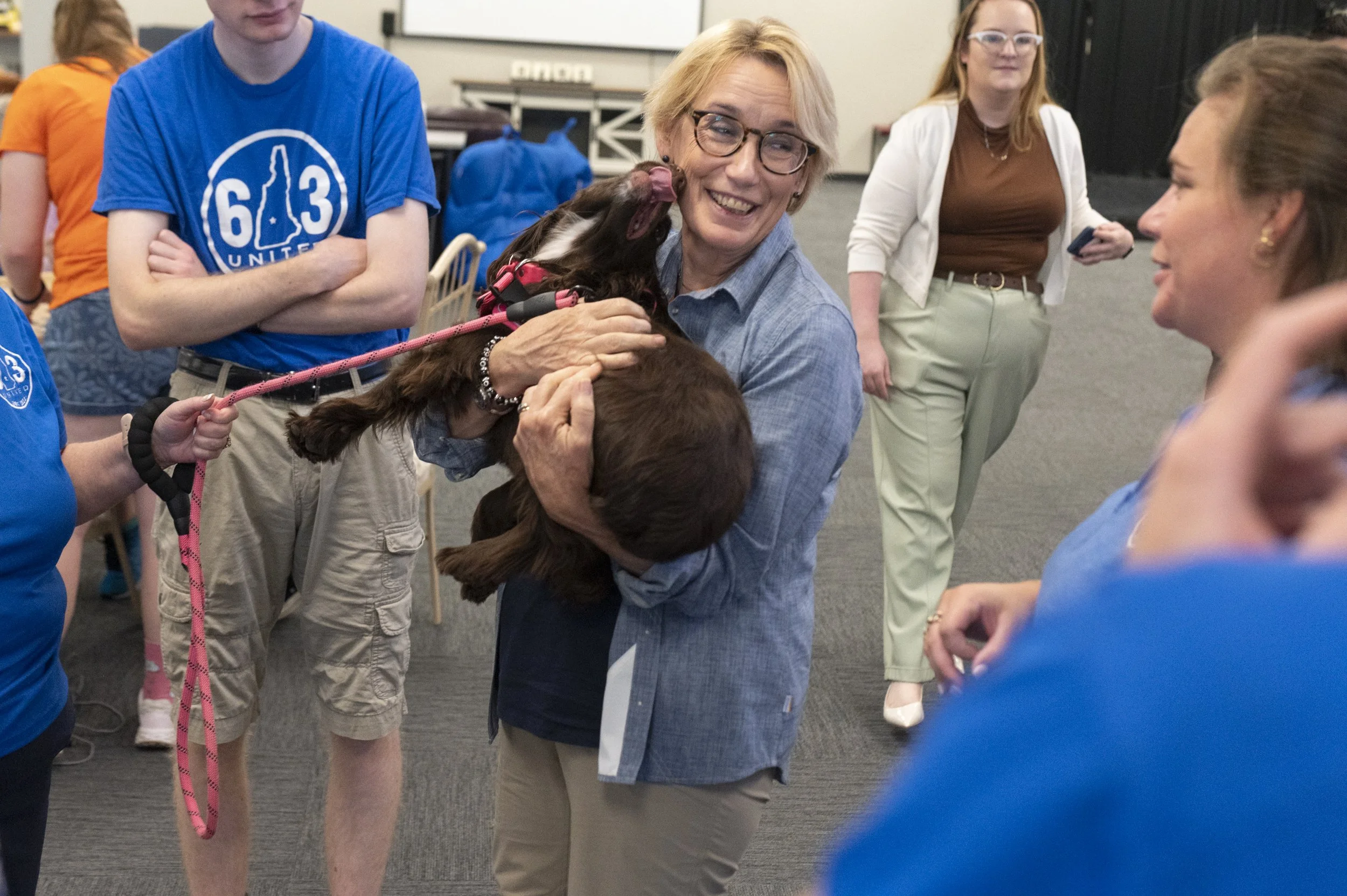  Senator Maggie Hassan holds one year-old Millie, the therapy dog, as she visits 603 United at the Belknap Marketplace in Belmont, N.H., on Aug. 7, 2024. 