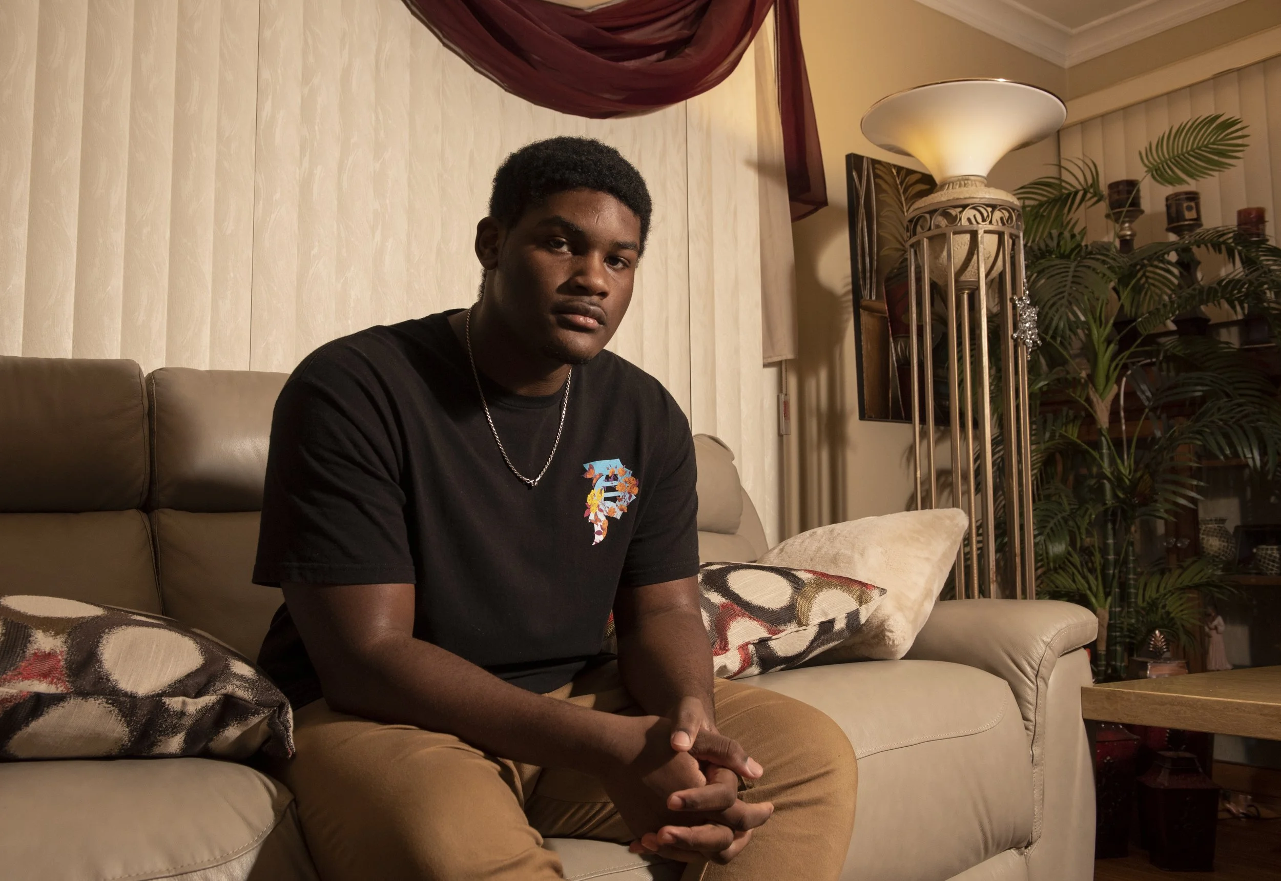  Jaylen Wims, 17, sits in his home in Rochester, N.Y. on Feb. 22, 2022. Wims lives in Rochester, but is transported to Pittsford Sutherland High School by the Urban Suburban organization. They bring inner-city students to suburban school districts to