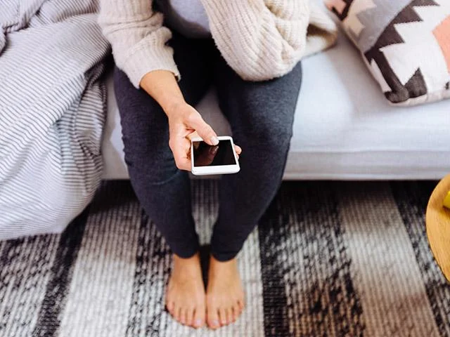 woman_looking_at_phone_next_to_her_bed__medium_4x3.jpg