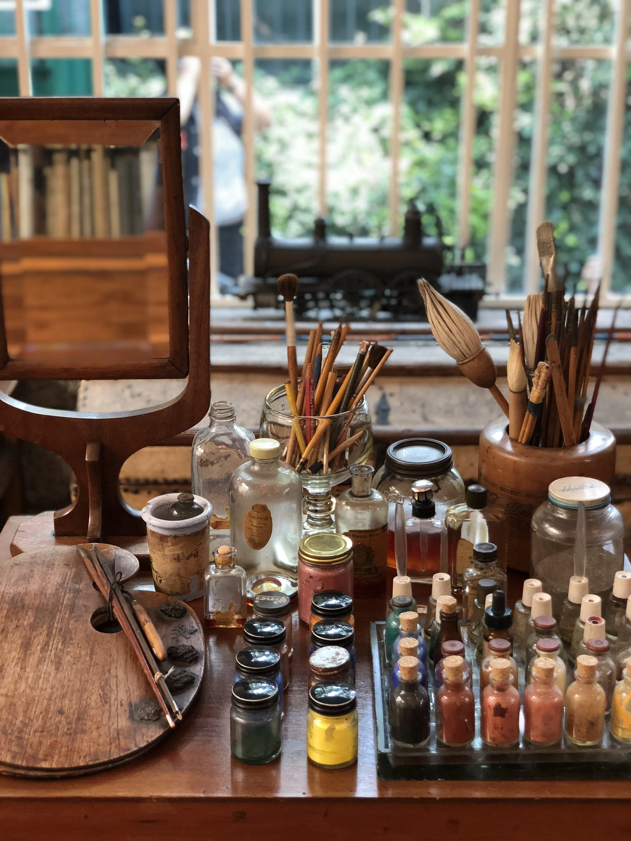 Perfume flasks and varnish jars which Frida used to hold her paint. Just as how she left it.