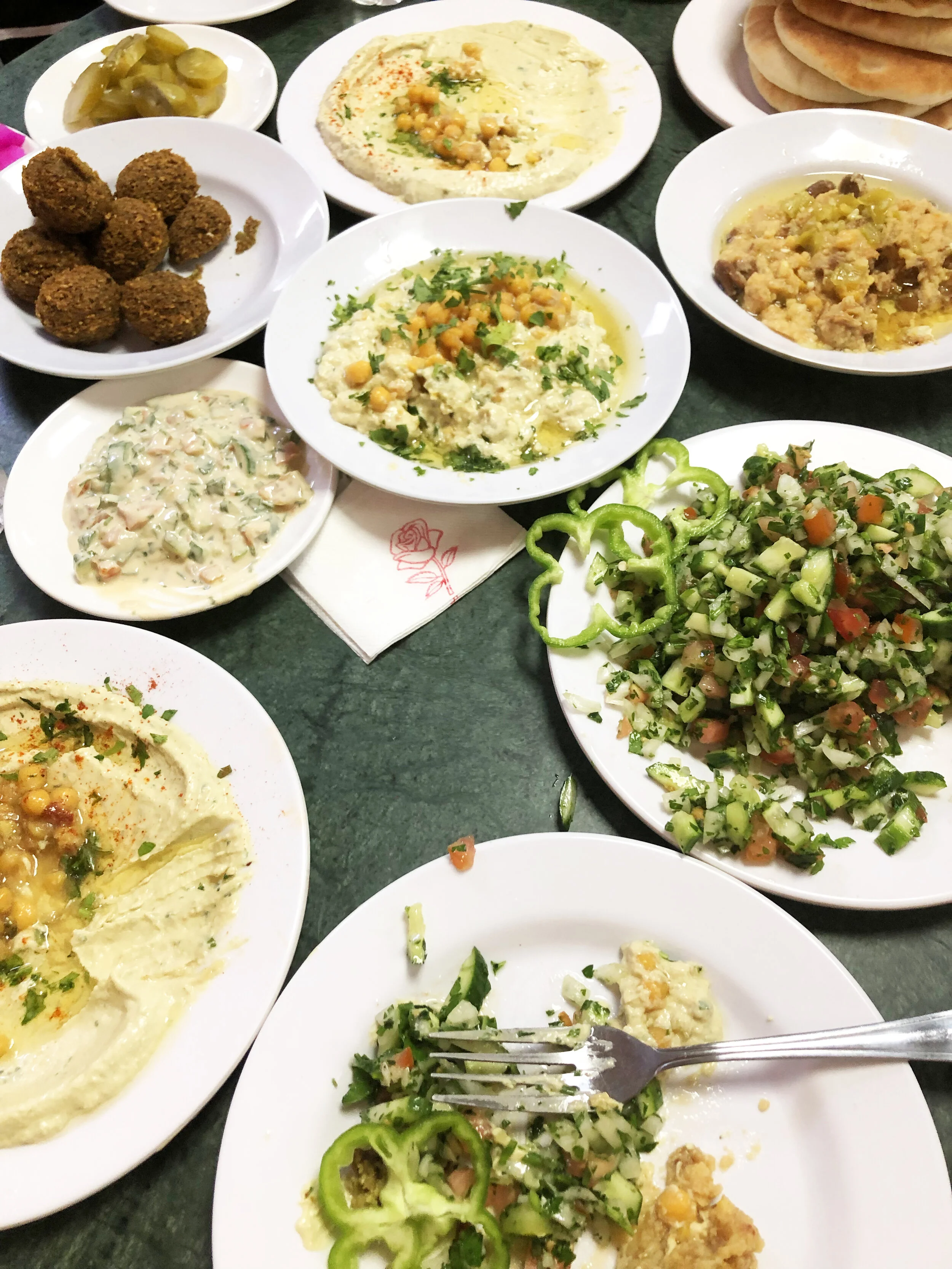 Traditional breakfast: vegetables, hummus, and falafel.