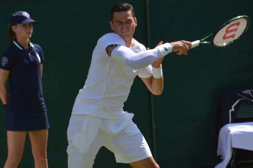 Milos Raonic wearing a compression sleeve at Wimbledon 2014