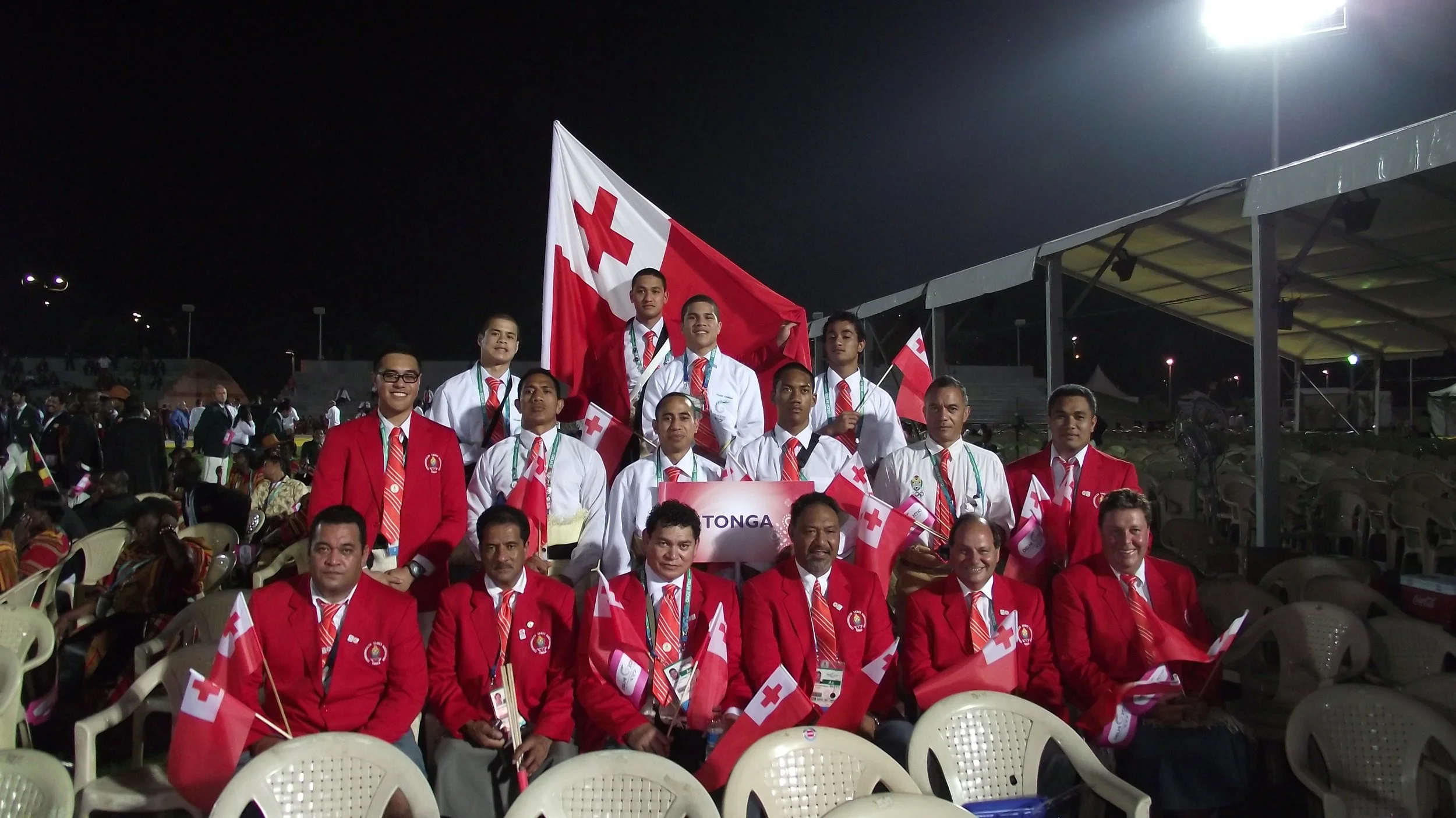 Team Tonga 2010 (minus the Rugby 7s players) at the Opening Ceremony Notable team members are Bronze medalists – Junior Fa (flagbearer) and Lomalito Moala both boxers plus an International calibre boxing coach Lolo Heimuli (MMA fighter Mark Hunt’s coach).