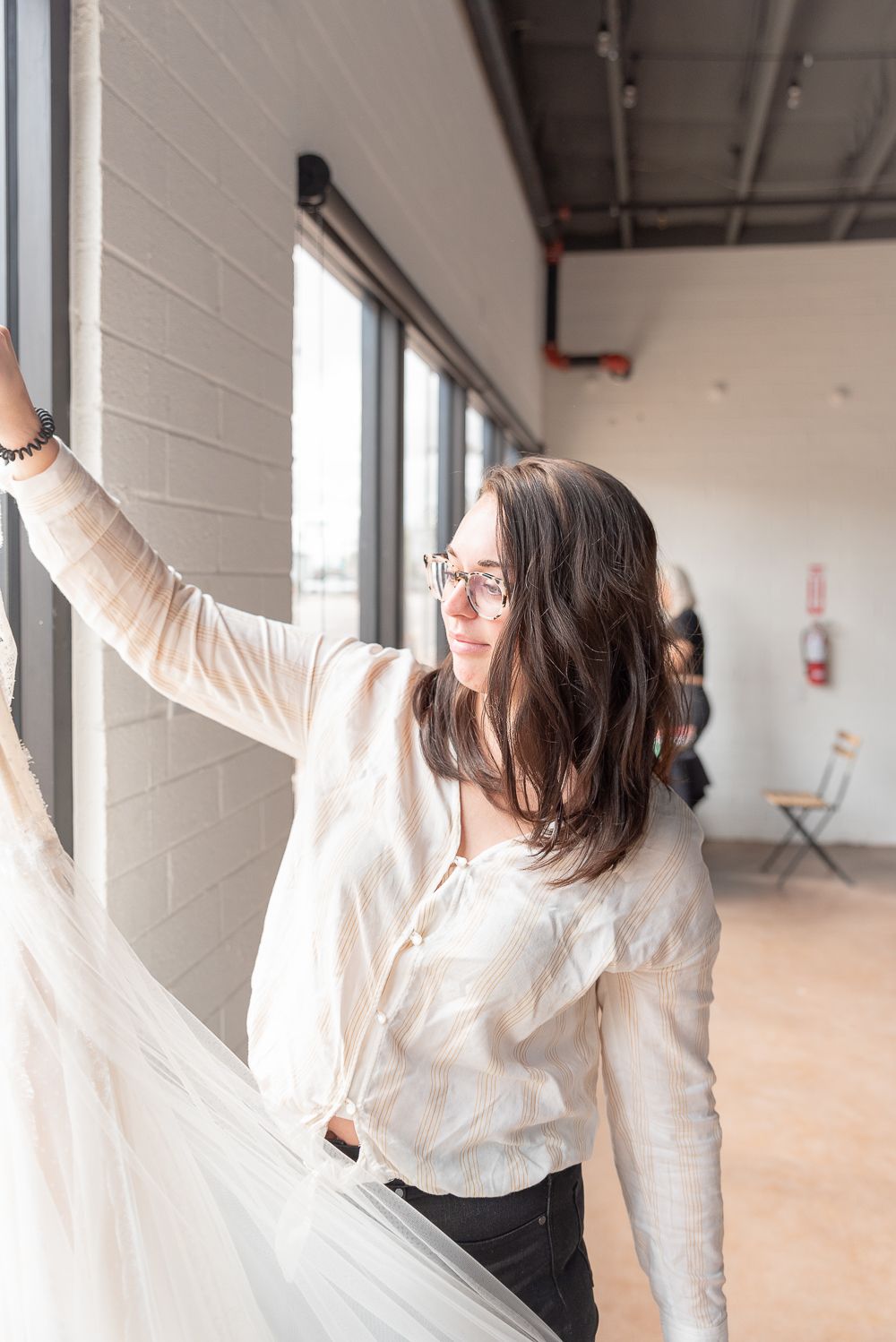 A little BTS shot of Owner and Creative Director of Neue Bride, Sydney getting the dress ready.
