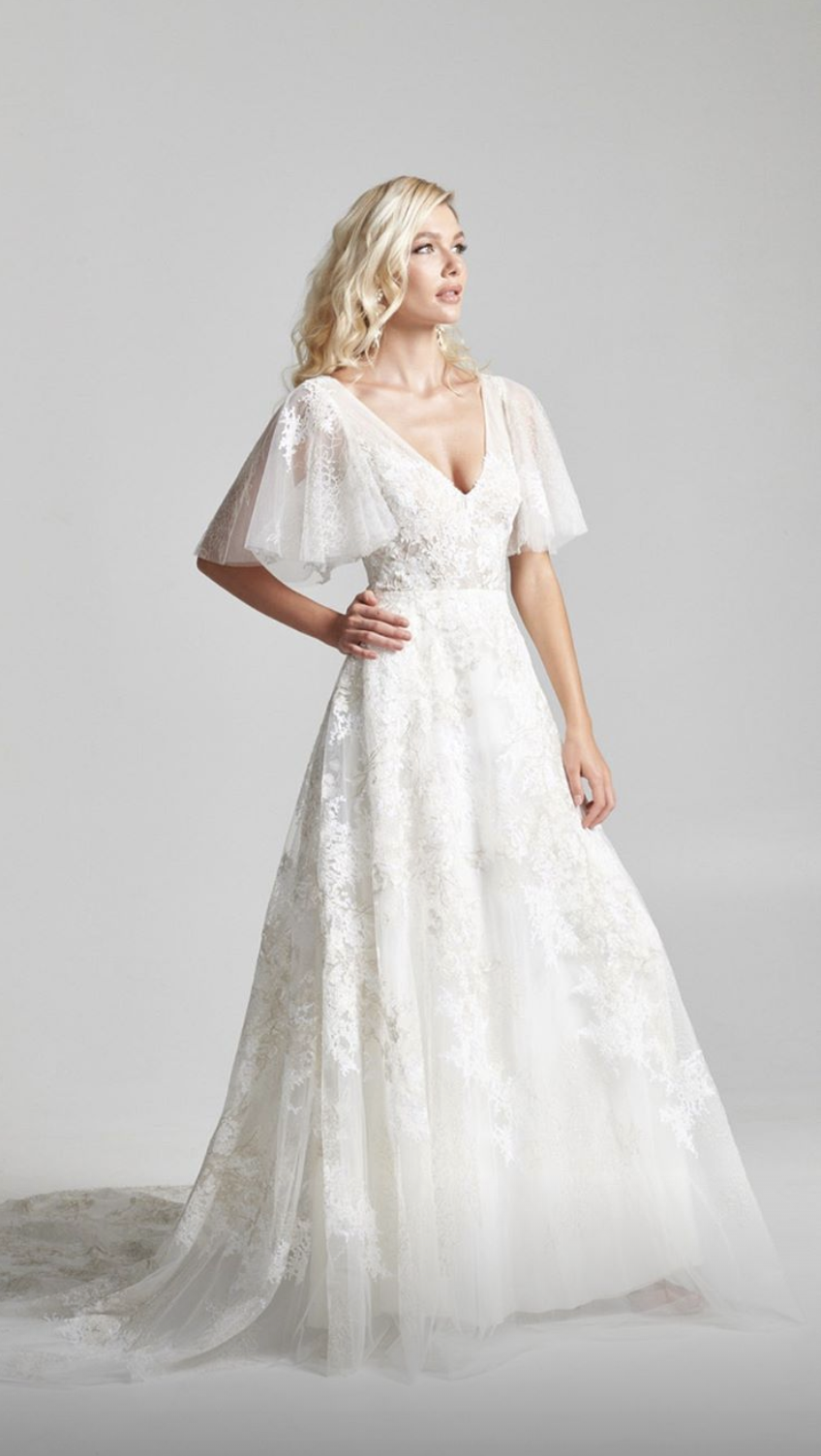 Rebecca Schoneveld 2020 bridal collection is available at Arizona Bridal Shop, Neue Bride in Mesa, Arizona! Come shop for modern wedding dresses like the Paloma A-line gown with flutter sleeve and beautiful intricately embroidered train.