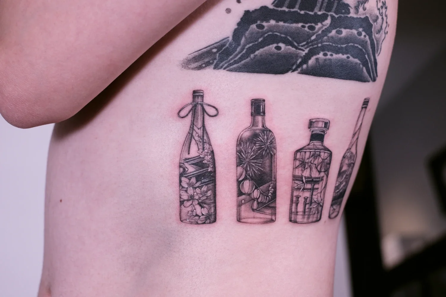 fineline-tattoo-japanese-bottles-seasons1.webp