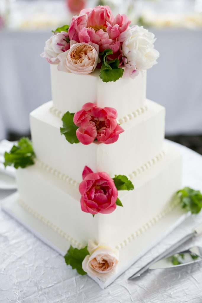 Delicious Designs By Sherry Thomas - 3 Tier square cake. Almond cream icing  with Red icing roses, Red pearls and a touch of red jemstone at the base of  each cake. Serves 100 | Facebook