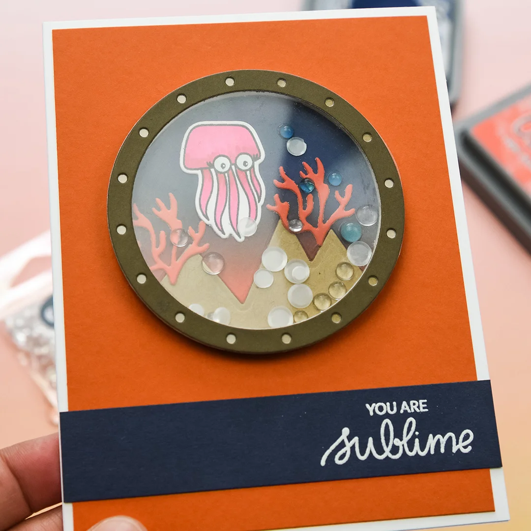 Shaker created using the Essentials by Ellen Porthole Die , Alpine Window die and Subbing In stamp set.