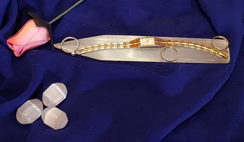 Selenite Flat Clearing Wand with jewelry on scarf.jpg