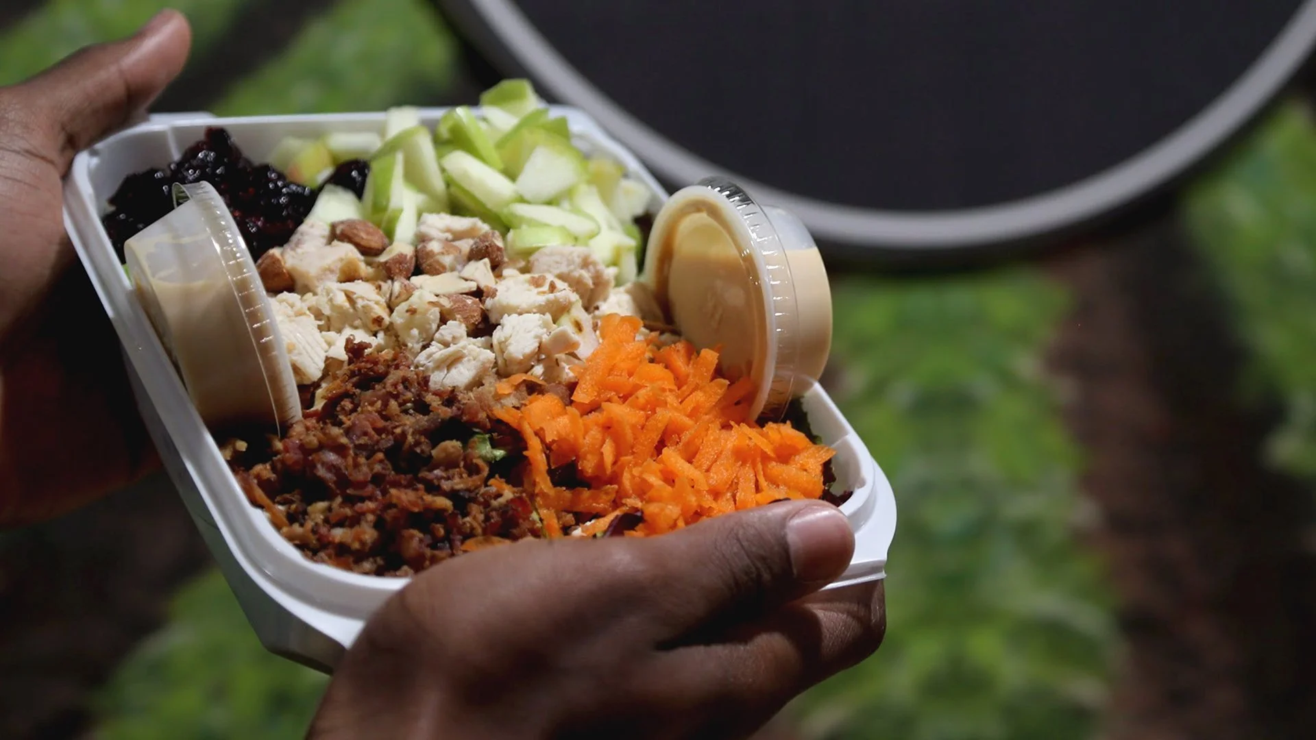 Freshly prepared Zookz salad with mixed greens, carrots, grains, and chicken breast in a meal prep bowl..jpg