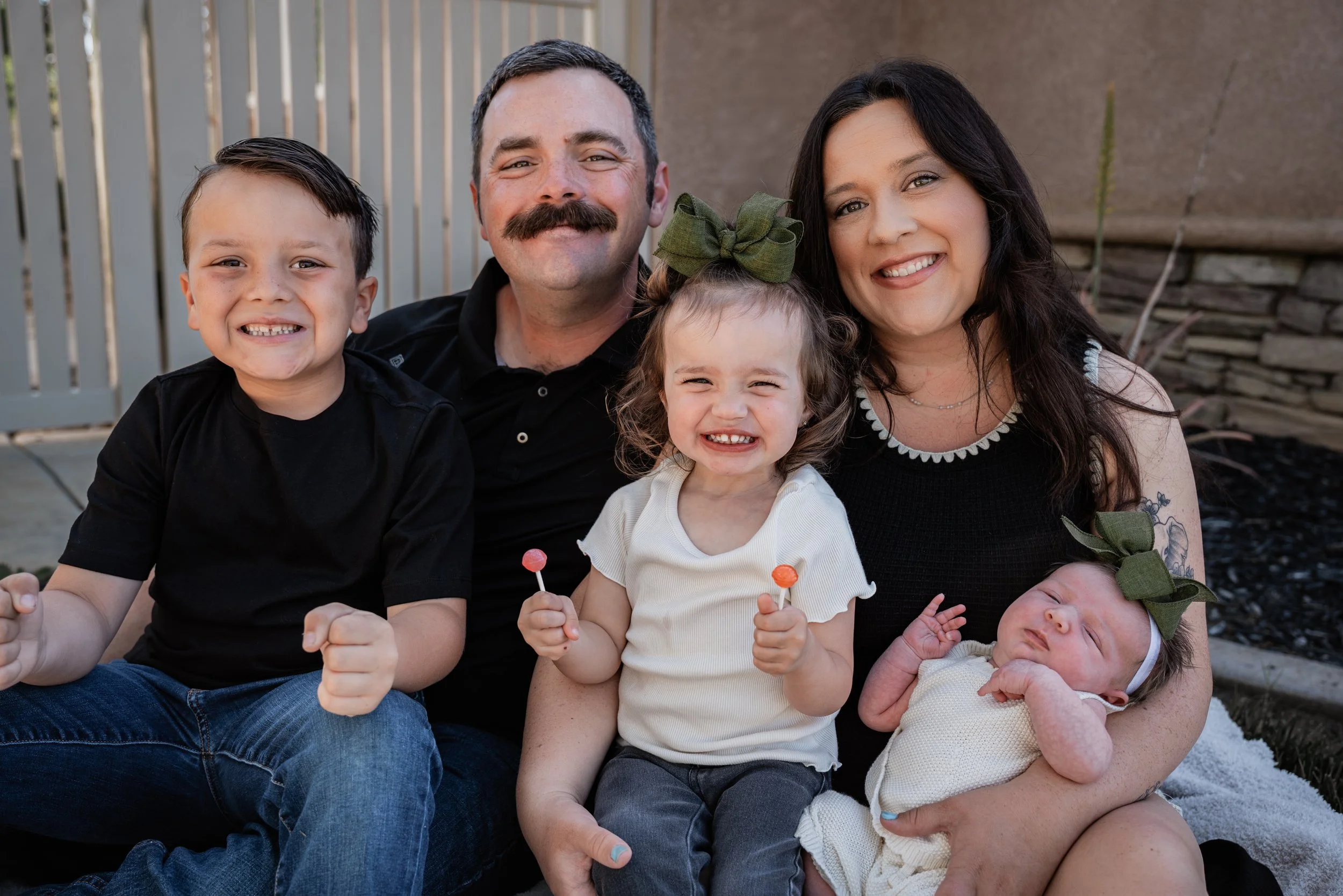 Family of 5 posing sitting for a photo. Photo taken in Patterson, CA by local family photographer Mikaela Tosta Photography.
