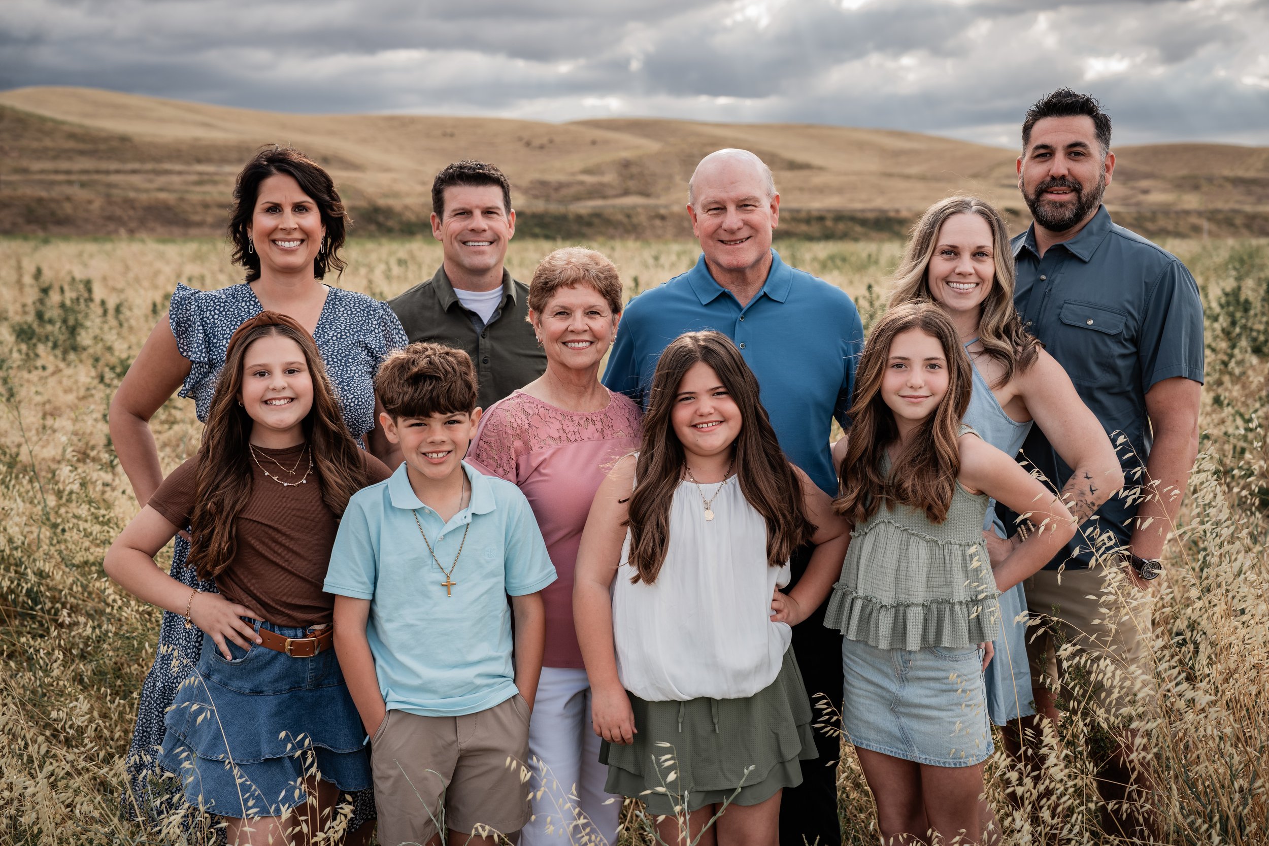 Multigeneration family standing in an open field. Photo taken by family photographer, Mikaela Tosta Photography in Patterson, CA.
