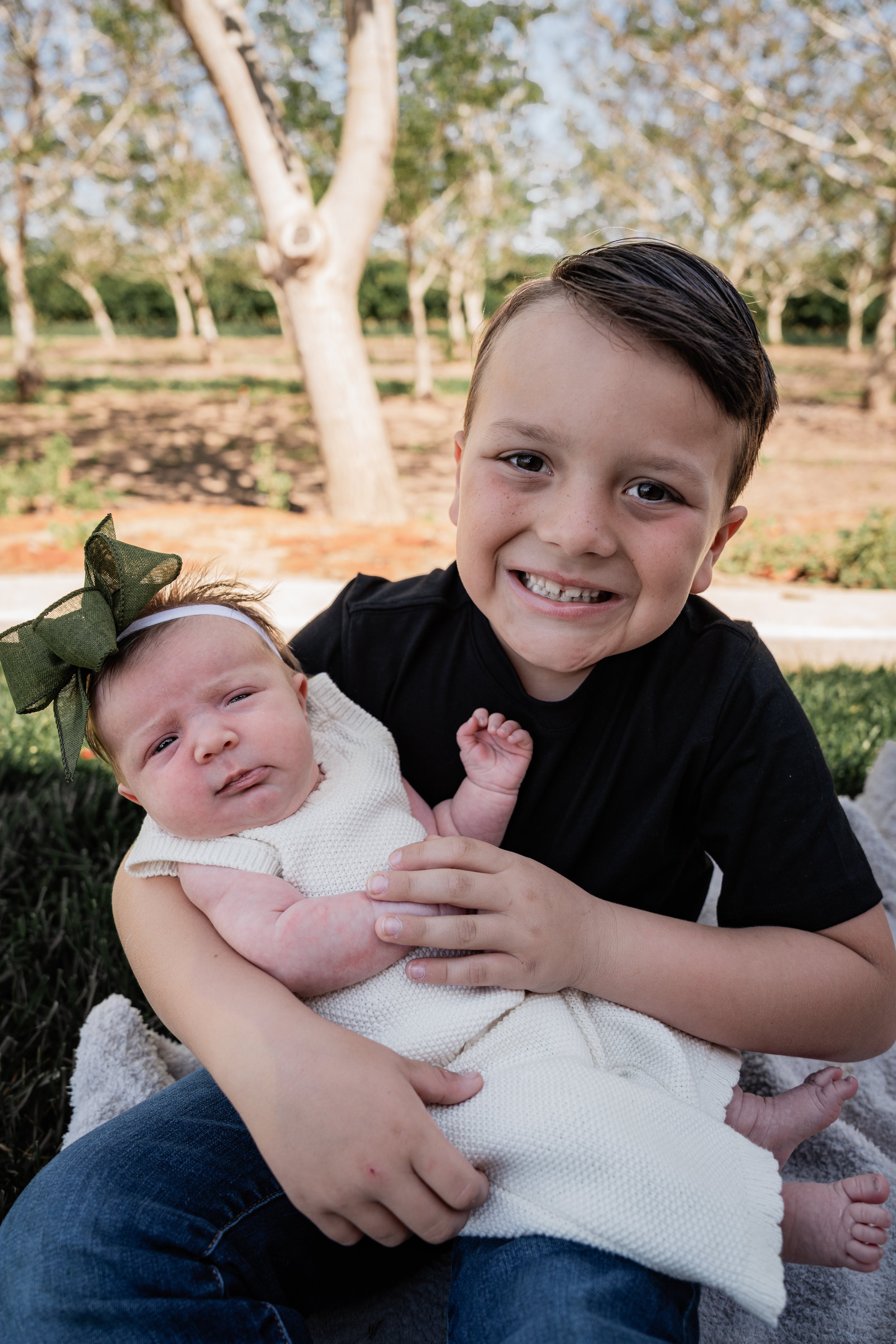 older brother holding his baby sister. Photo taken in Patterson, CA by local family photographer Mikaela Tosta Photography.