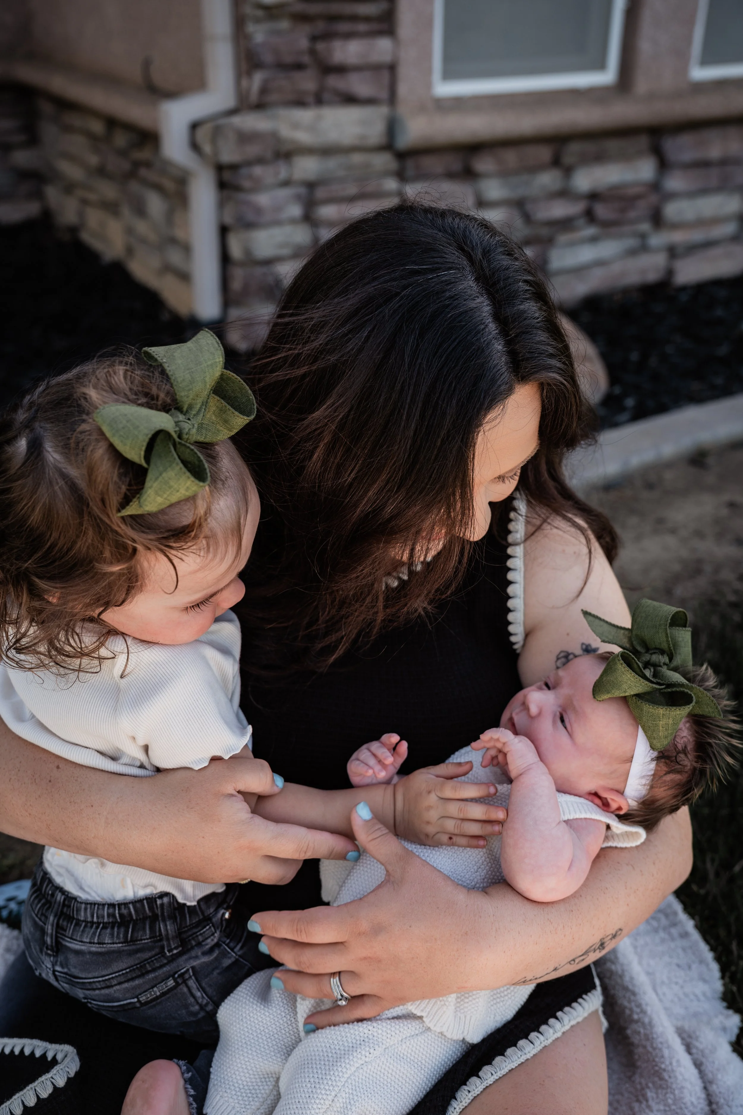 Mom looking at her two daughters. Photo taken in Patterson, CA by local family photographer Mikaela Tosta Photography.