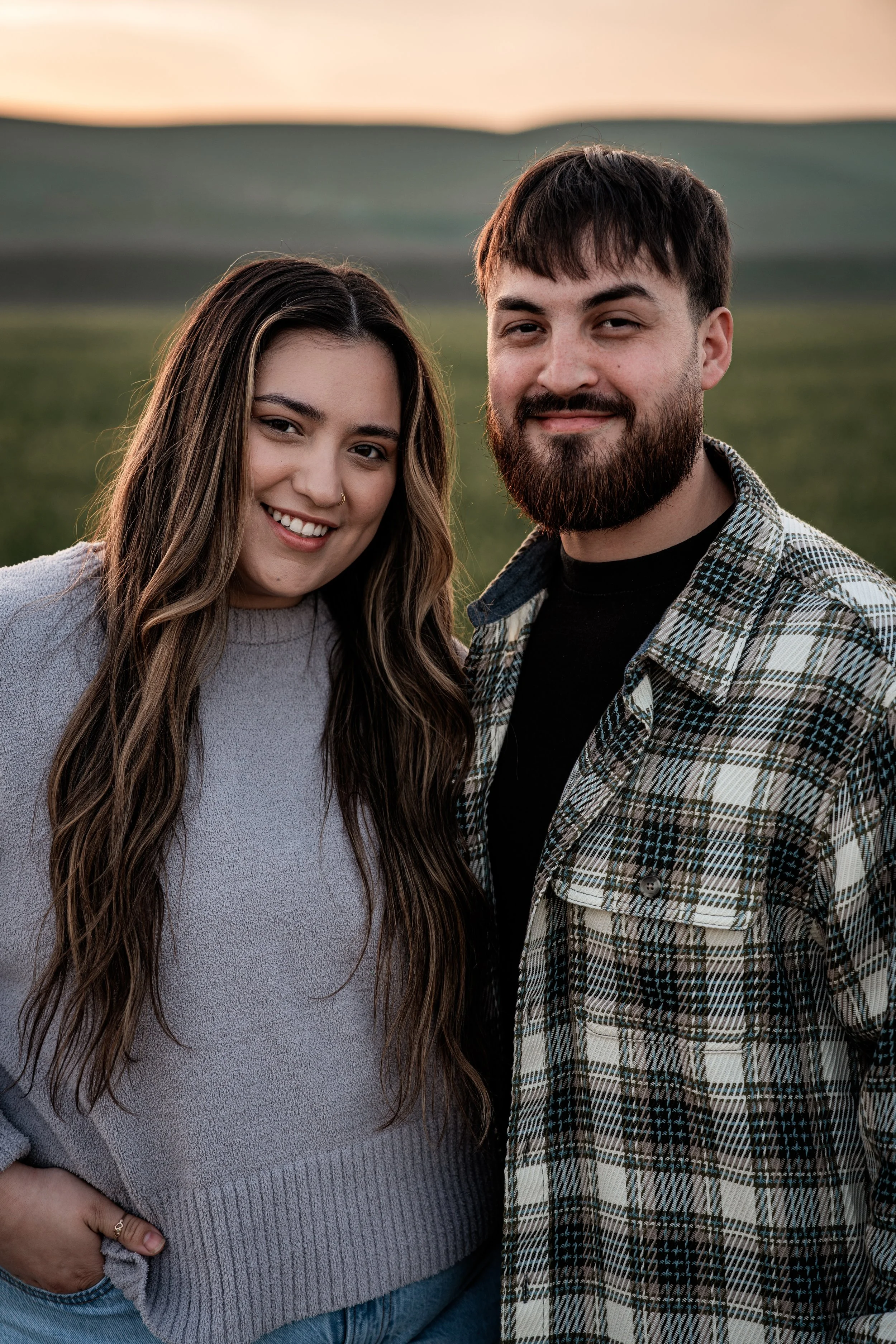 Couple standing in an open field. Photo taken by family photographer, Mikaela Tosta Photography in Patterson, CA.