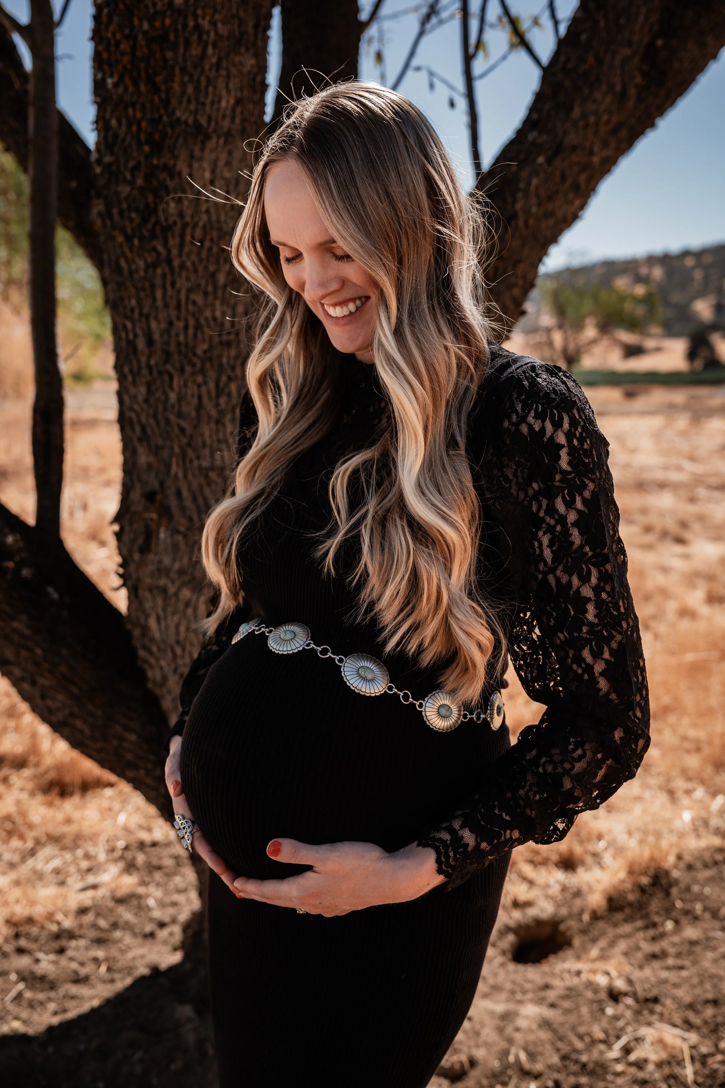 Pregnant woman posing with her baby bump in Capay, CA. Photo taken by maternity photographer, Mikaela Tosta Photography.