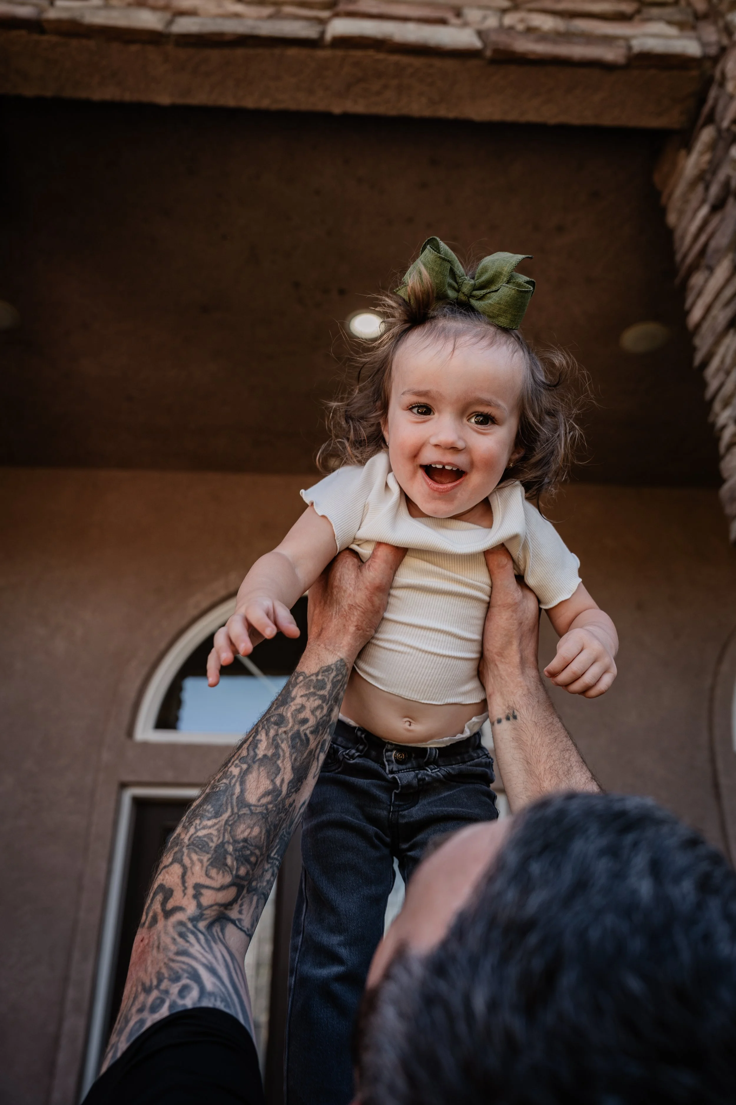 Dad holding daughter in air. Photo taken in Patterson, CA by local family photographer Mikaela Tosta Photography.