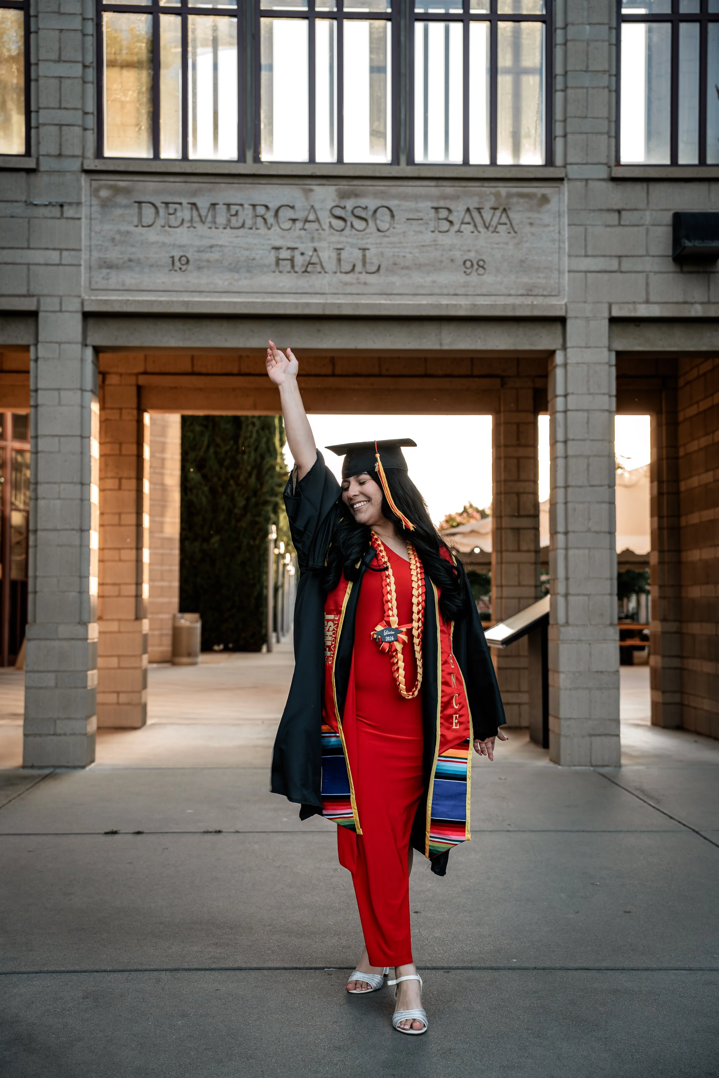 Photo of a Stanislaus State Graduate in front of DBH. Photo taken in Turlock, CA by senior photographer and grad photographer Mikaela Tosta Photography.