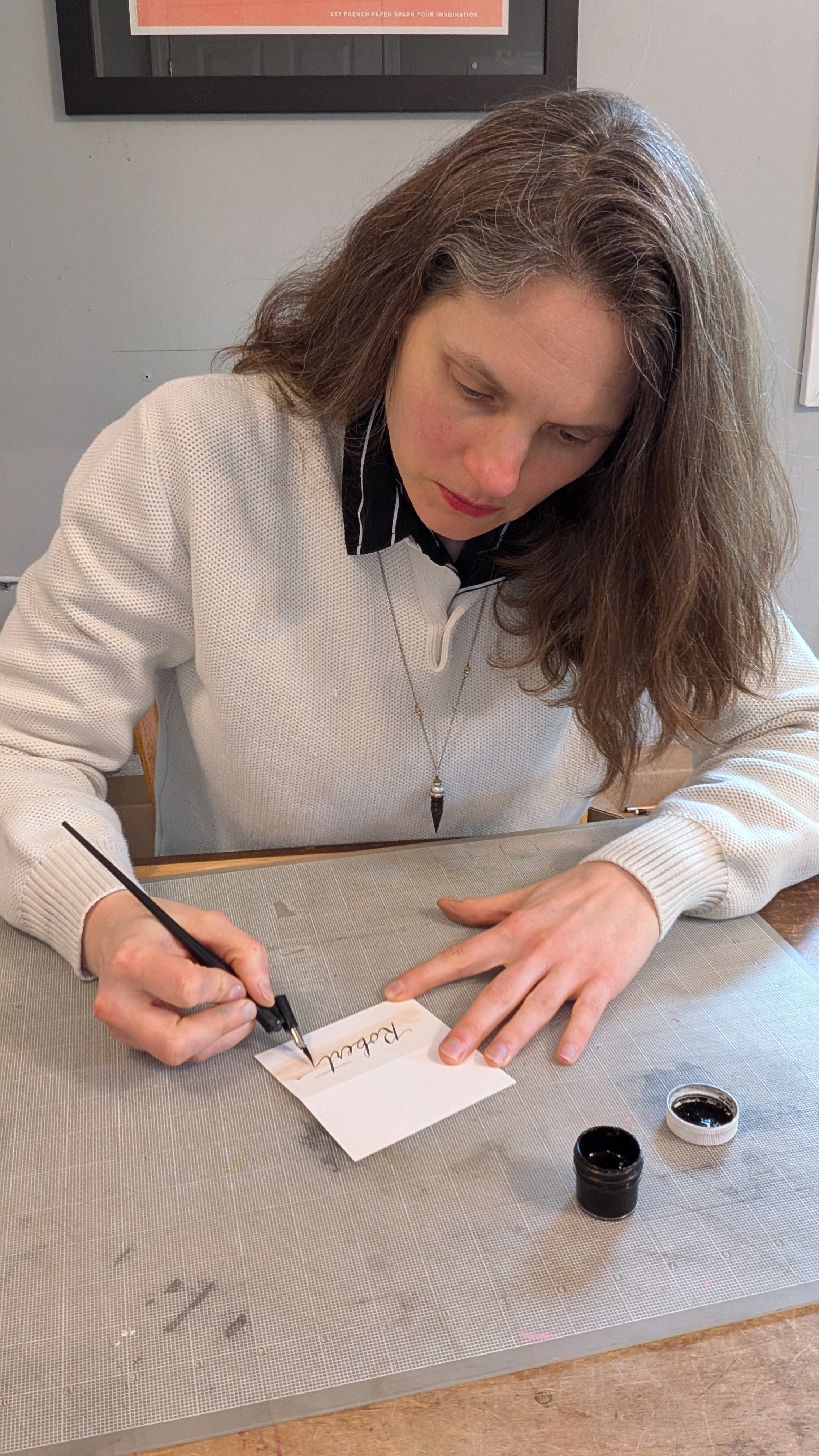 Rhode Island calligrapher hand lettering place card with pen and ink in studio