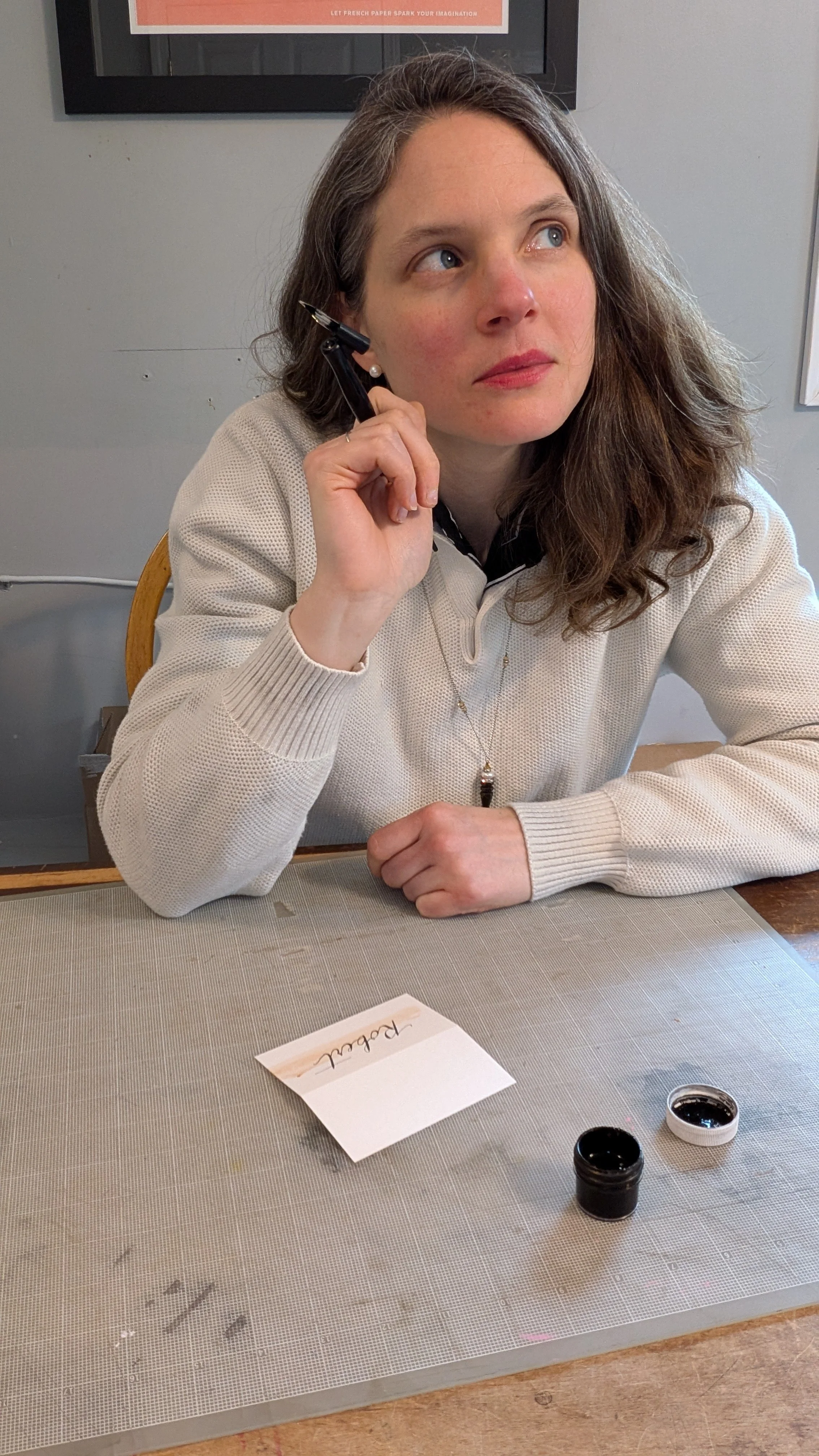 Rhode Island calligrapher planning custom calligraphy project in studio workspace