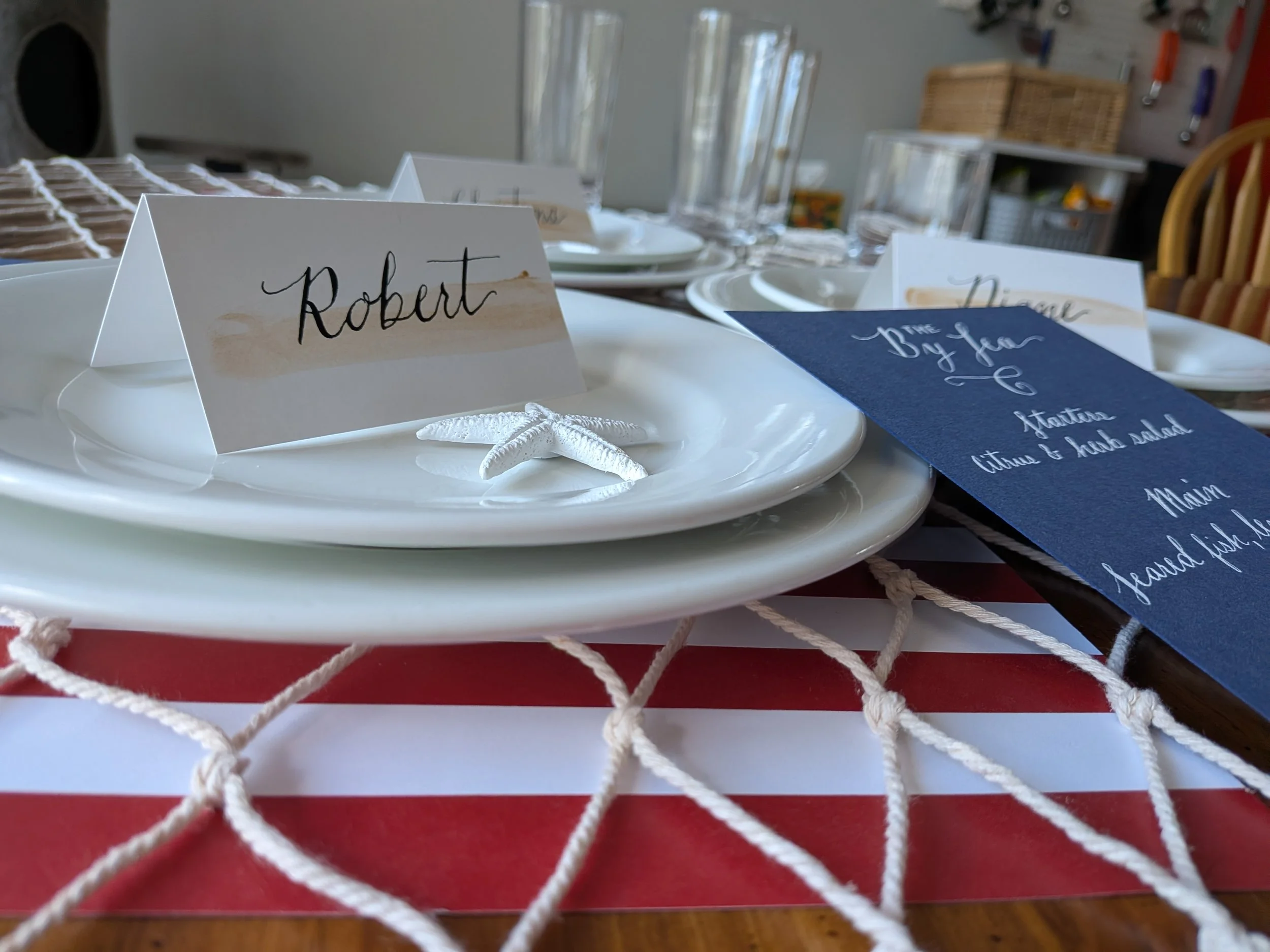 calligraphy menu and handwritten place cards styled on coastal table setting for Rhode Island wedding