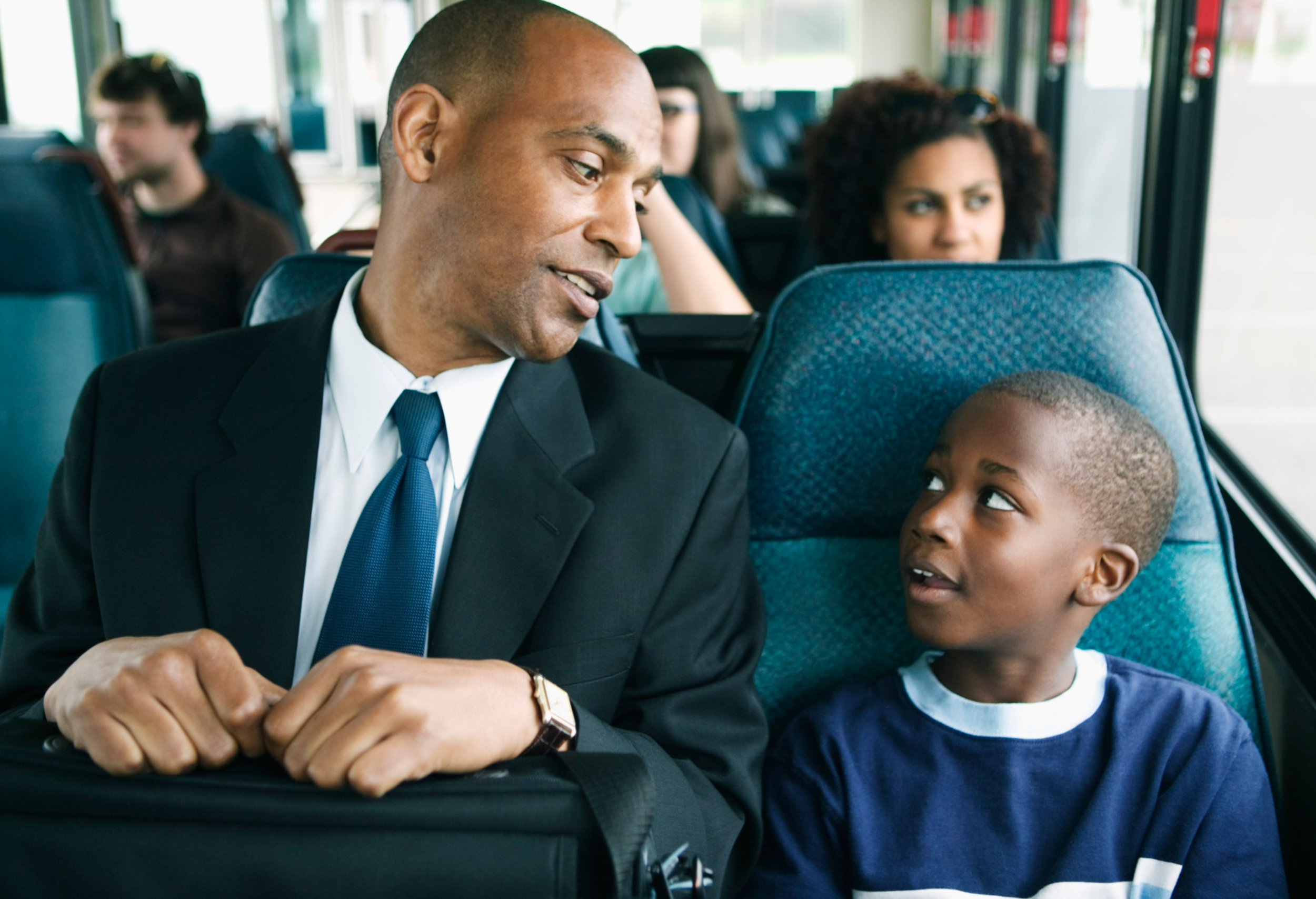 A father with his son on the bus. (Courtesy of Canva)