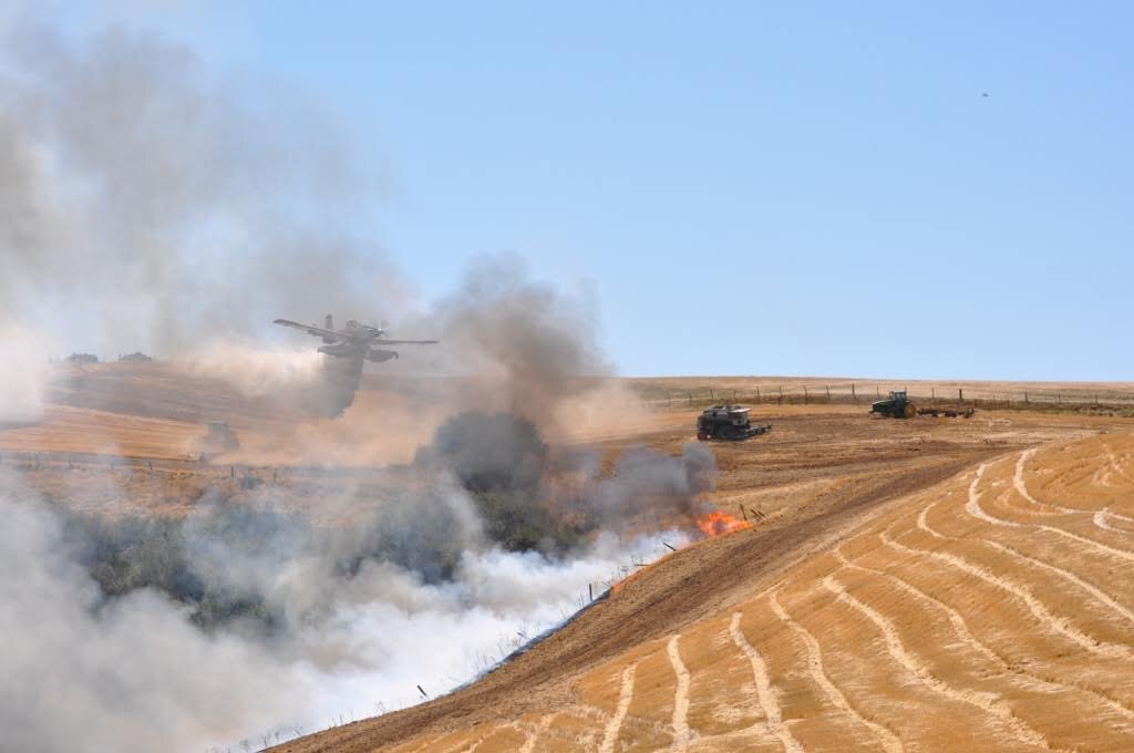 Fire Boss approaching grass fire to make a drop.jpg