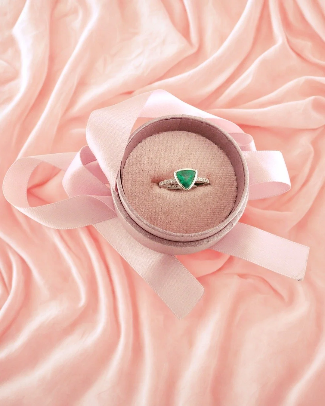 This 1.10 carat trillion cut emerald is bezel set in white gold and accented by .12 carats total of round brilliant cut diamonds, perfectly showcasing the vibrant color of this beautiful emerald. Whether you're celebrating a milestone or you simply w