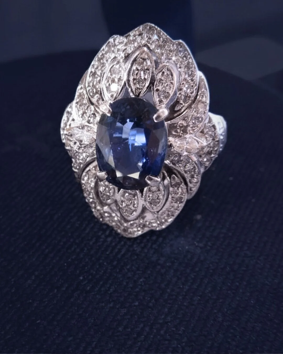 This stunning vintage-inspired platinum ring features a vibrant 3.40ct oval cut blue sapphire accented by .60ctw of diamonds. Whether you're looking to make a statement at a special occasion or simply want to elevate your everyday style, this showsto