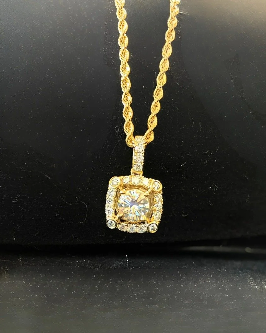 This dazzling pendant features 1.125 carats total of natural diamonds that add the perfect amount of brilliance and fire. Set in 14 karat yellow gold, it's the perfect accent to a classic rope chain.