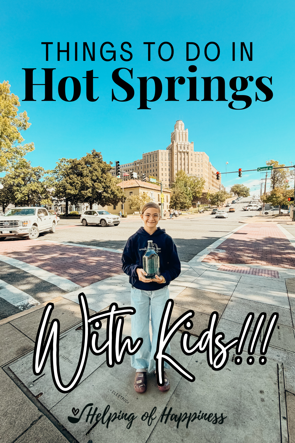 Pinterest graphic featuring a child holding a Hot Springs National Park water jug in downtown Hot Springs, Arkansas, with the title “Things to Do in Hot Springs with Kids.”
