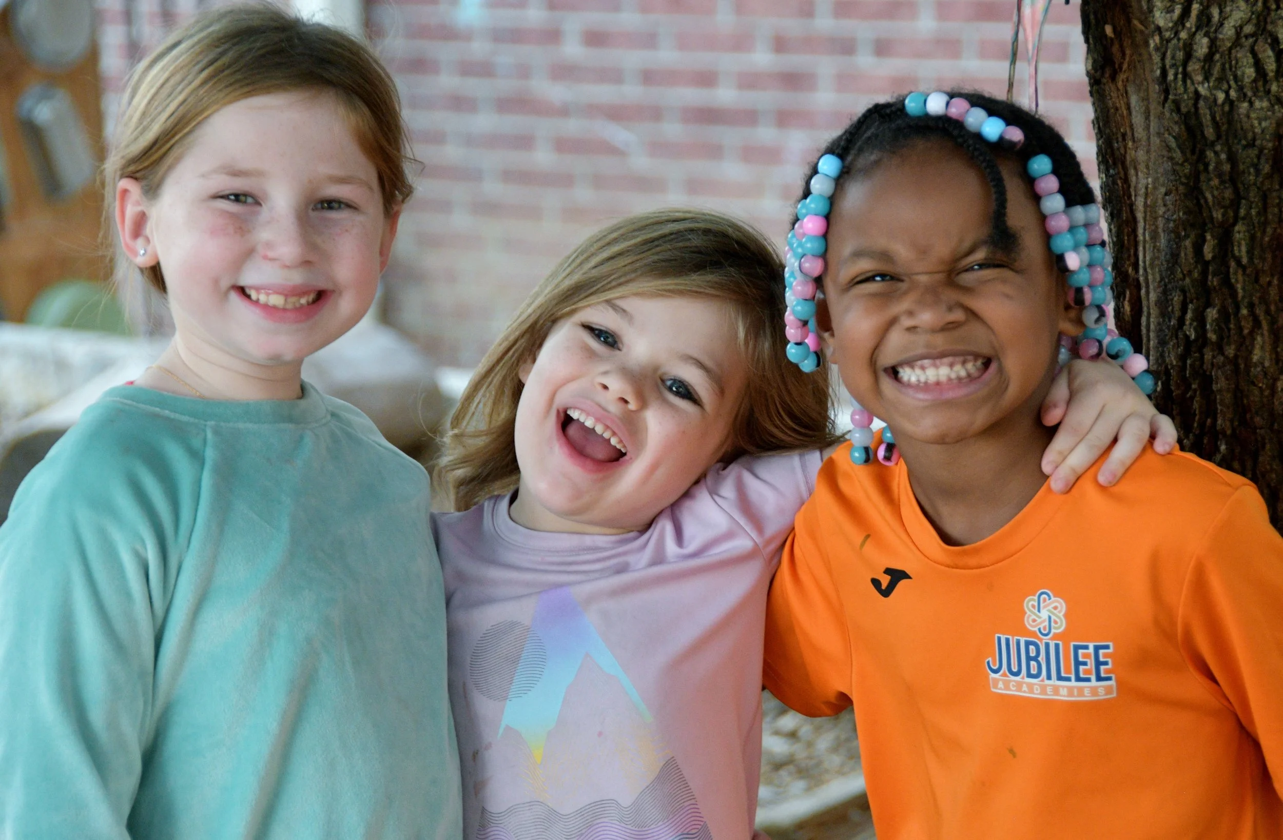 Three friends smiling in our Pre-k 4 program