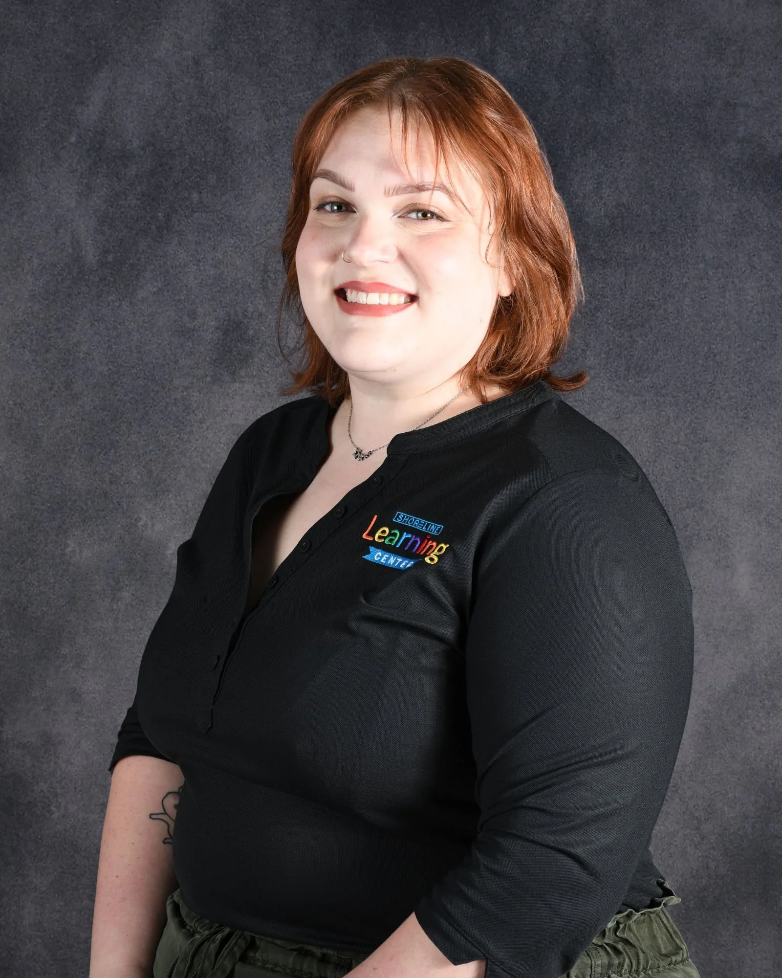 A woman smiling who is our front desk admin team to help all of the families and answer questions serving the Pflugerville, Round Rock, and Austin Texas area.